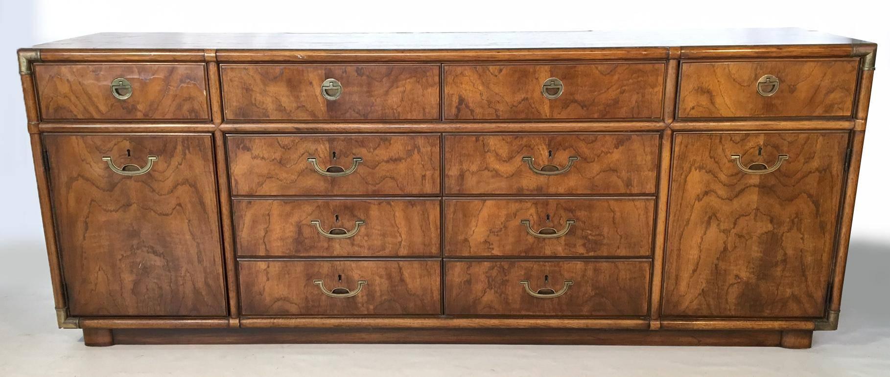 Impressive ten-drawer solid wood dresser by Drexel for their Accolade collection. Campaign style brass hardware and plinth base. Can be a bedroom dresser, or a living area credenza or buffet. Dovetail jointed drawers. Faux bamboo brass