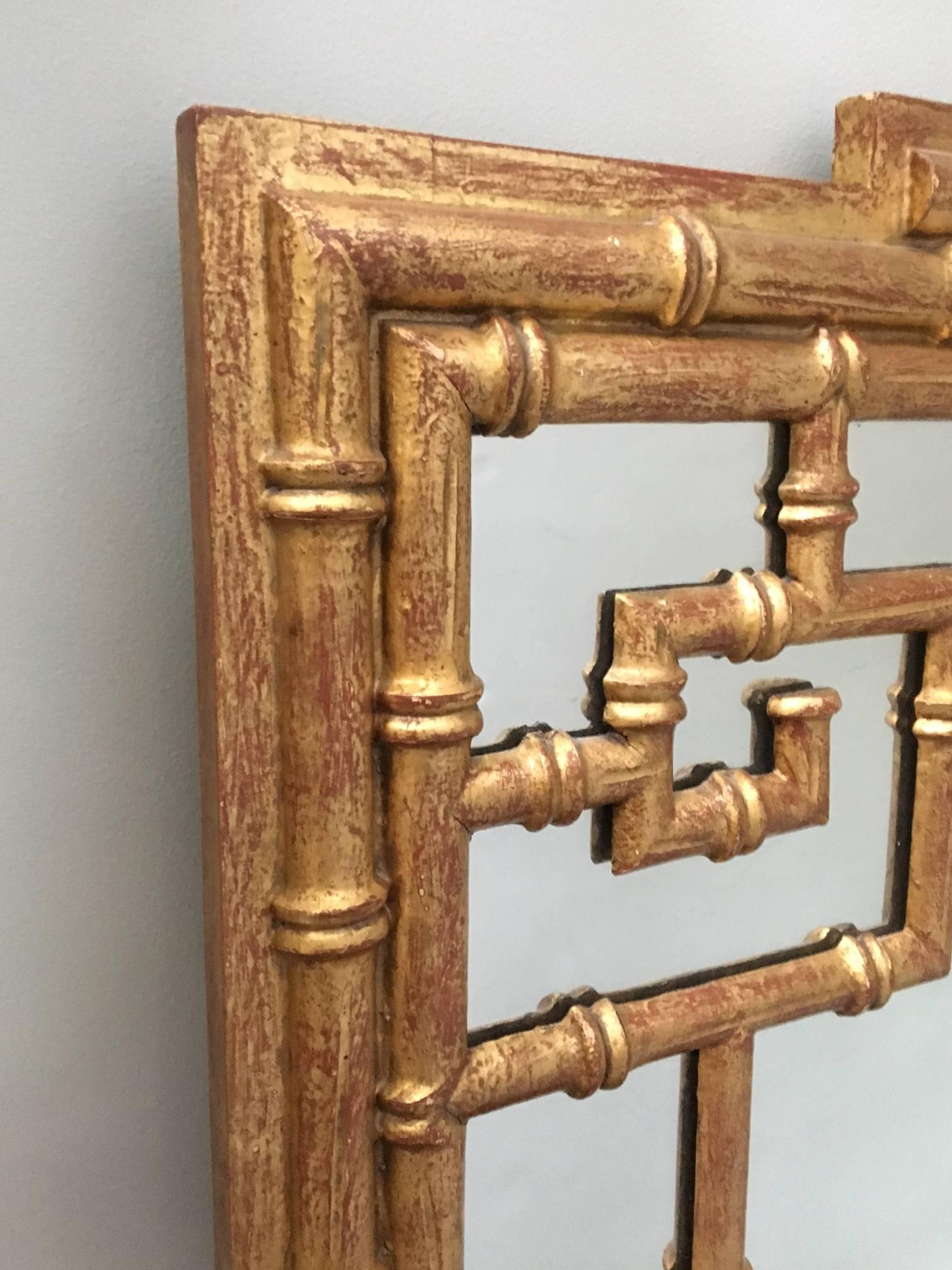 Large faux bamboo framed chinoiserie wall mirror lends just the right touch of Chinese influence to your decor. Excellent vintage condition.
