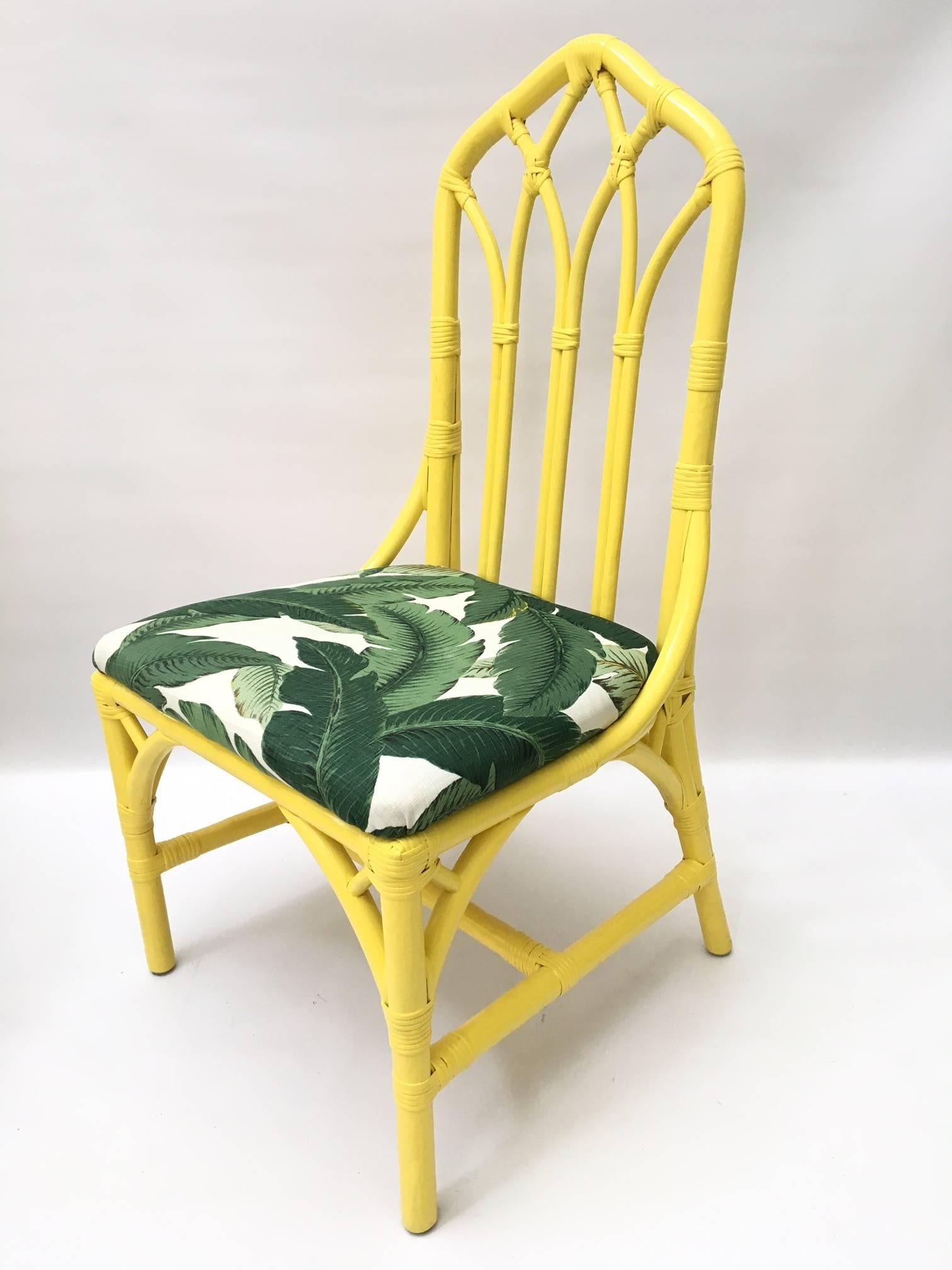 Fabulous set of six bamboo cathedral style dining chairs in bright yellow featuring palm leaf print upholstery. Excellent vintage condition.

Armchairs measure 22.5