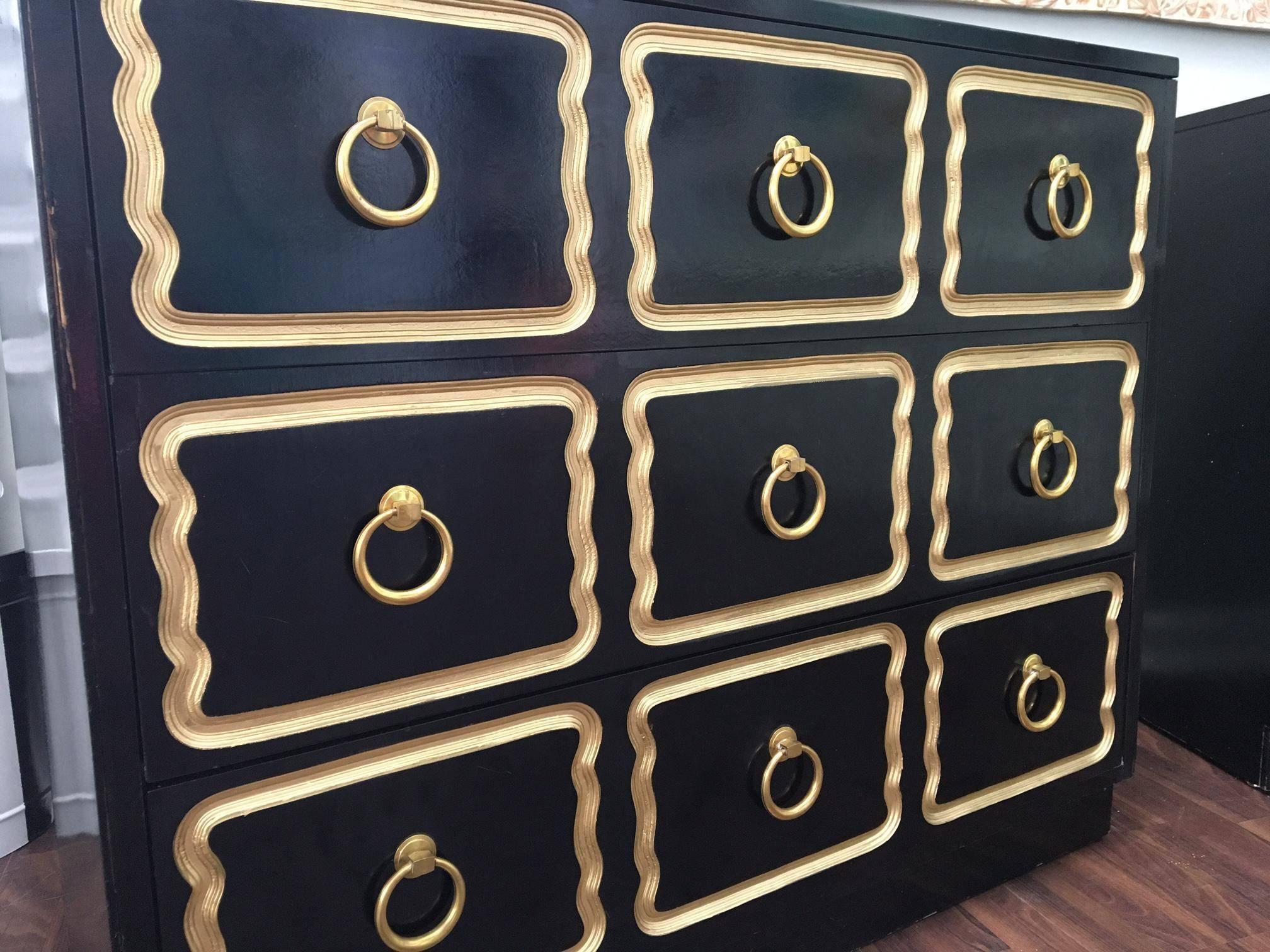 Pair of matching Dorothy Draper style Espana dressers in the iconic black with gold trim. Features brass hardware and dovetail jointed drawers. Good vintage condition consistent with age. 