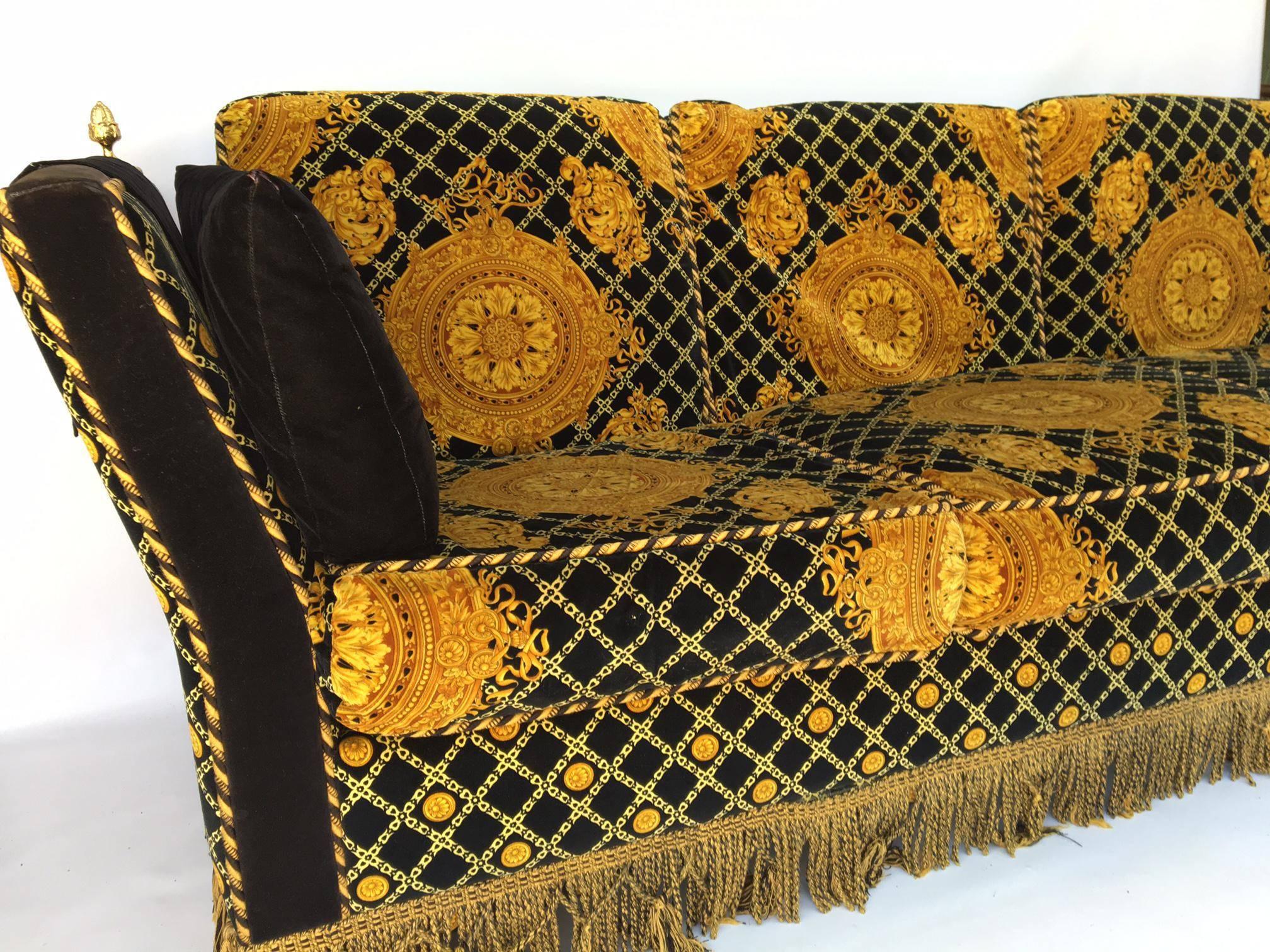 Rare Knole style sofa upholstered in plush velvet with a Gianni Versace inspired print. Adorned with brass finials. Marked Stefano Giovanni (Jiovanni) and made in Italy. The Knole settee dates back to the 17th century and this 1980s version is