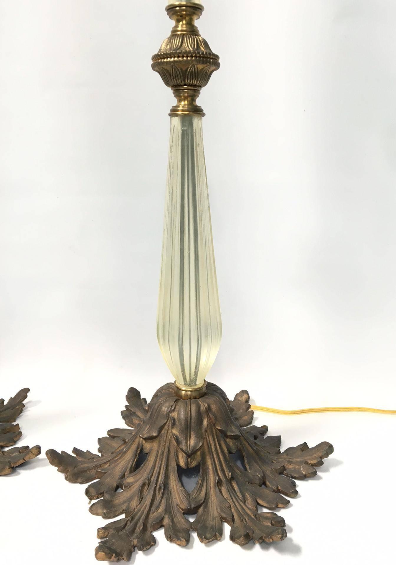Large Murano Italian table lamps feature sculptural glass and brass colored accents on an ormolu base molded in the acanthus leaf characteristic of the renaissance style. Each lamp stands over 45