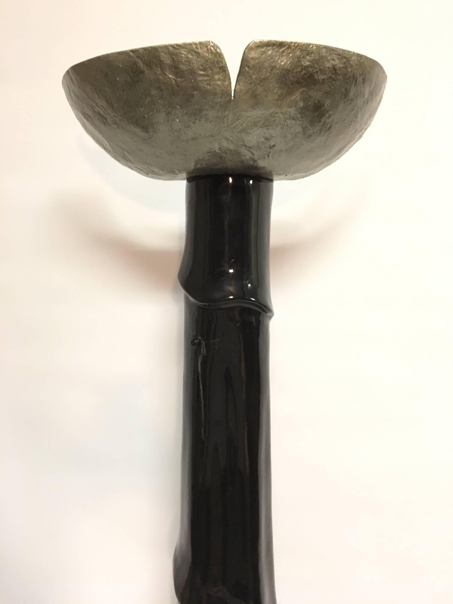Unusual sculptural floor or wall lamp designed to stand against a wall. Tall base with carved drape form with silver shade. Made of cast resin. Holds two standard light bulbs. Measures: Stands 74.5