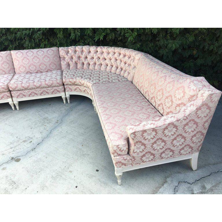 Hollywood Regency at it's best in this stunning four-piece sectional sofa, circa 1960s. Upholstery in near new condition. Unusual lines along top edge. Tufting at corner section. Very comfortable. Structurally sound throughout. Consists of four