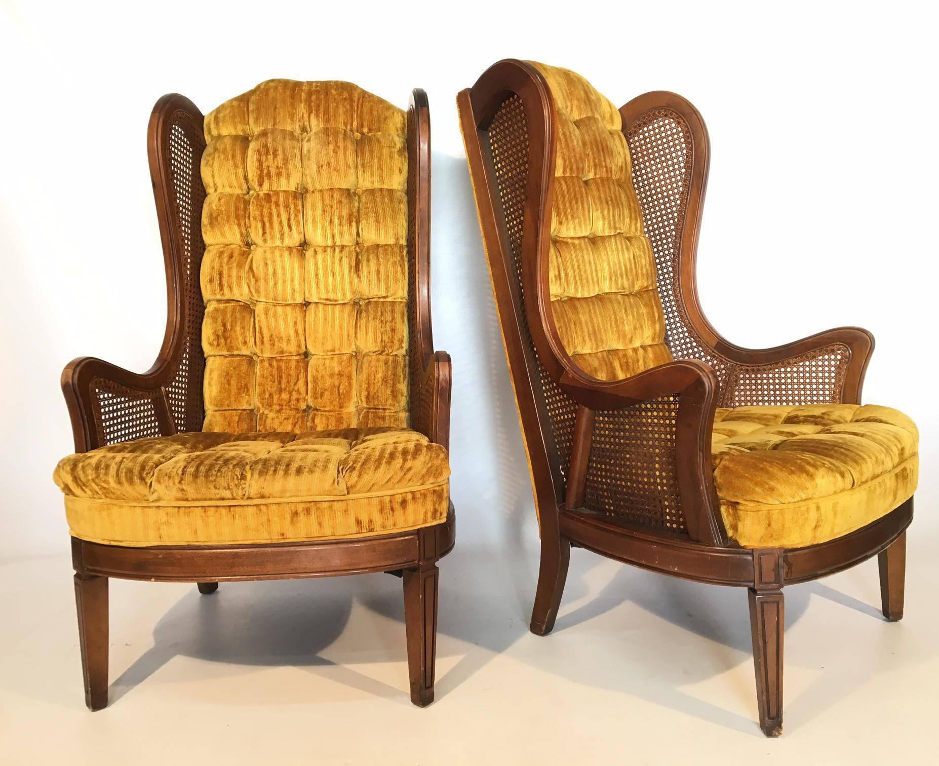 Pair of Lewittes cane wingback chairs in gold velvet. Features full tufting from back to seat. Caning in near perfect condition. Upholstery in excellent condition and frame also in excellent condition, save for the slight wear on