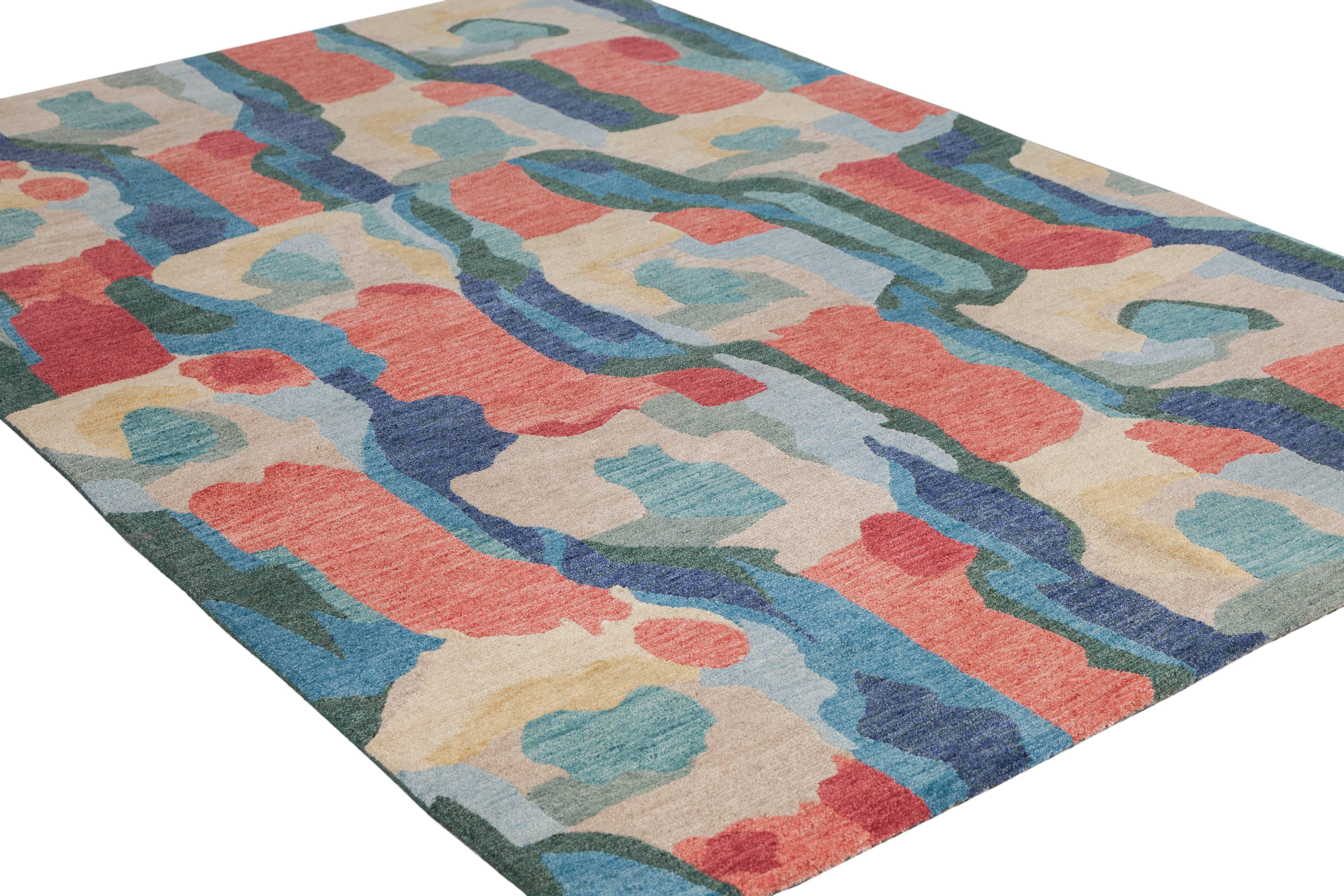 A expressionist backdrop of form and colors. Woven using pure Tibetan wool, this coloration features tones of khaki, marigold yellow, navy, teal, hunter green, sky blue and poppy red. This piece has been crafted by hand in our true 100 knot quality.