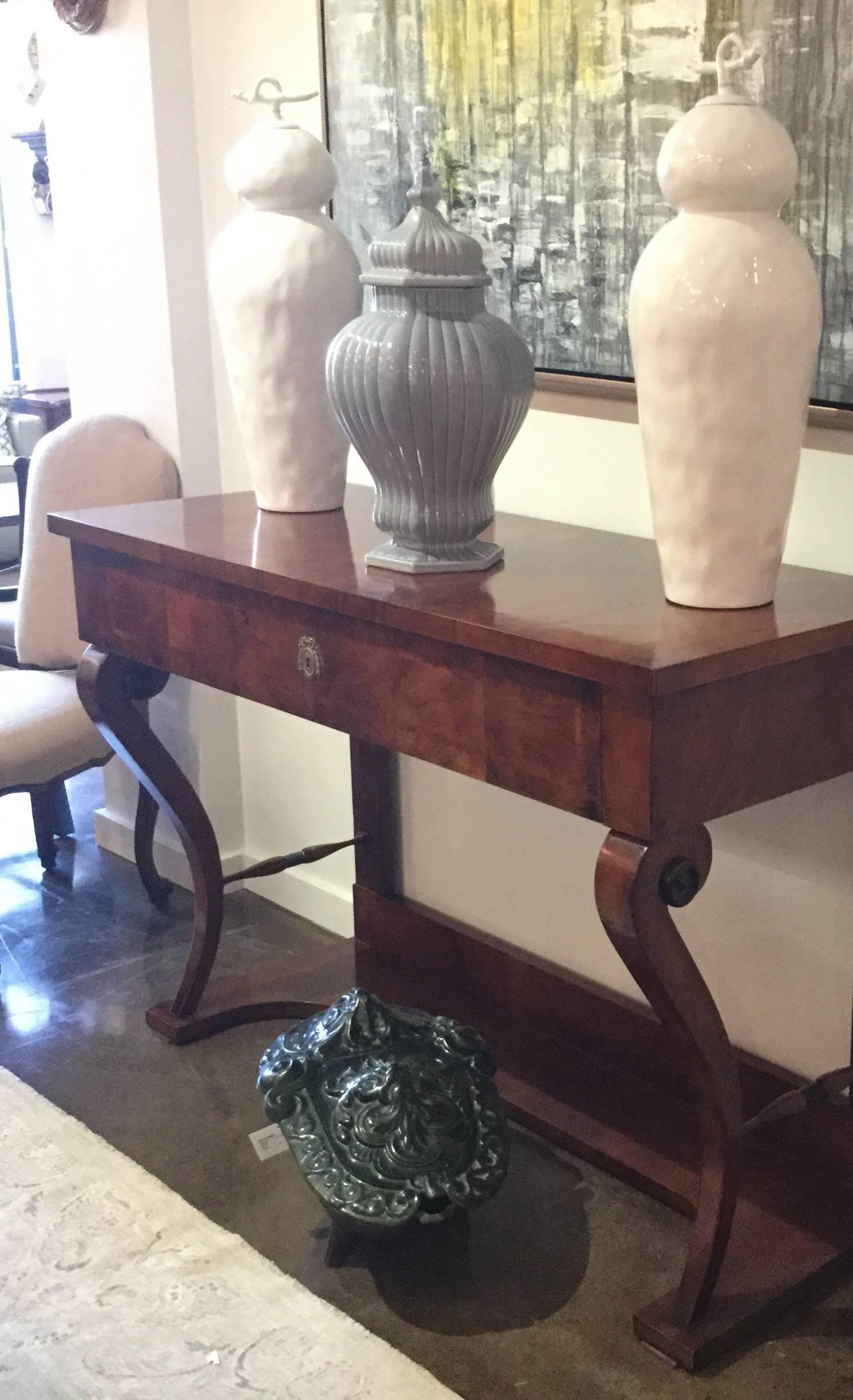 Empire-style, walnut inlaid console table with curved legs and a single drop front drawer accented with brass hardware, Italy.