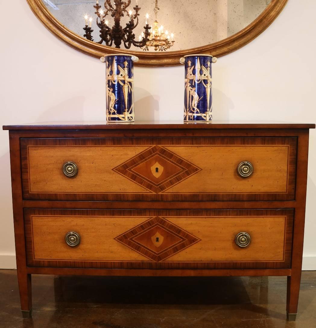 Walnut and maple French reproduction chest with two drawers. Diamond shaped inlay or rosewood and maple. Brass hardware and brass capped feet.