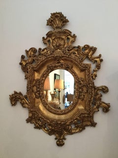 Pair of Ornate Oval Mirrors Hand-Carved Wood Finished in Aged Gold Leaf