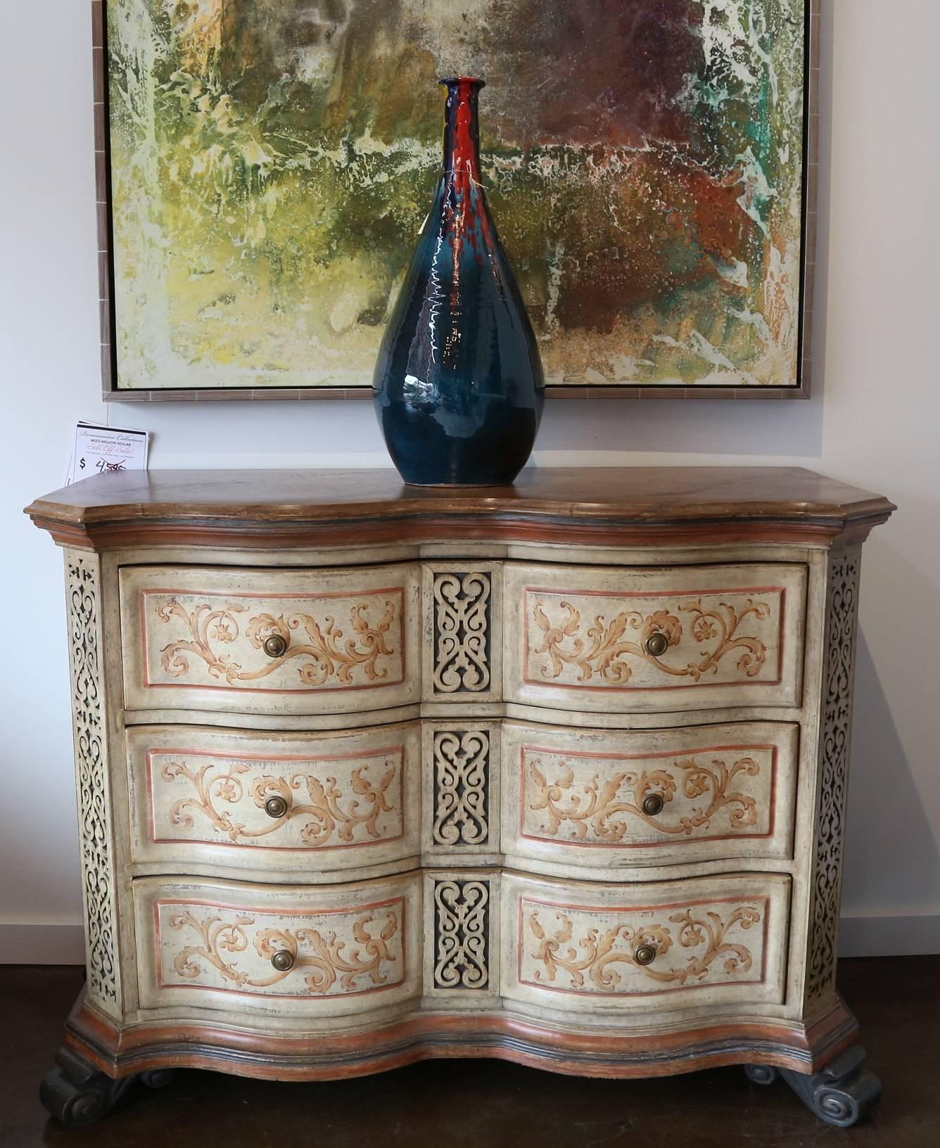 Hand-painted three drawer chest featuring a curved front accented with fretwork carving and faux marble-top in an aged ivory hand finish. Created by the artisans of Italy.