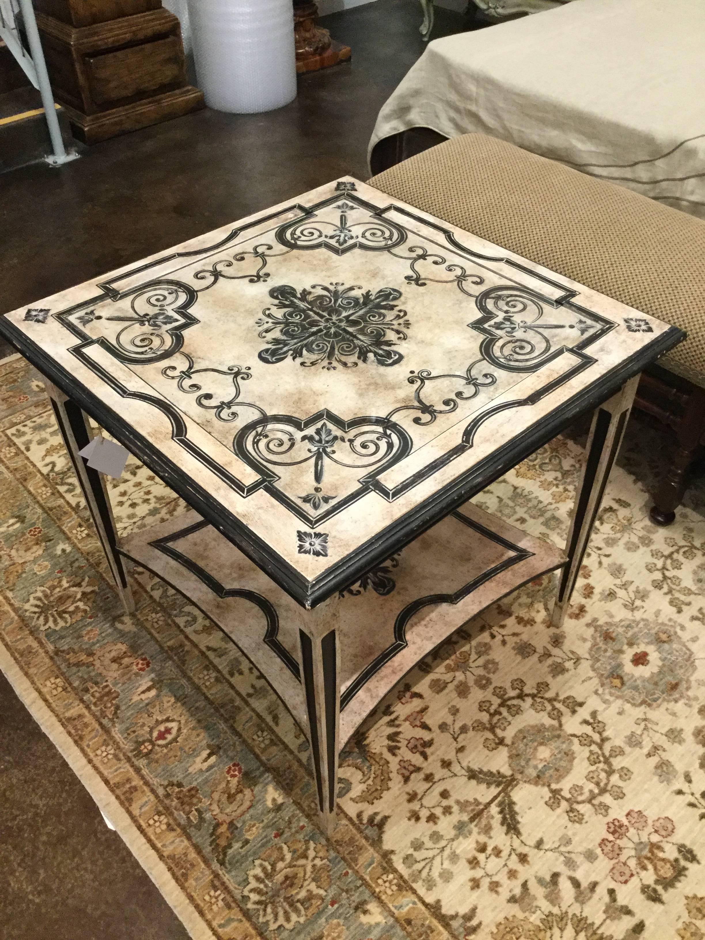 Hand-painted occasional table in distressed ivory with scrolling ebony accents, featuring a glass top.  Created by the artisans of Italy.