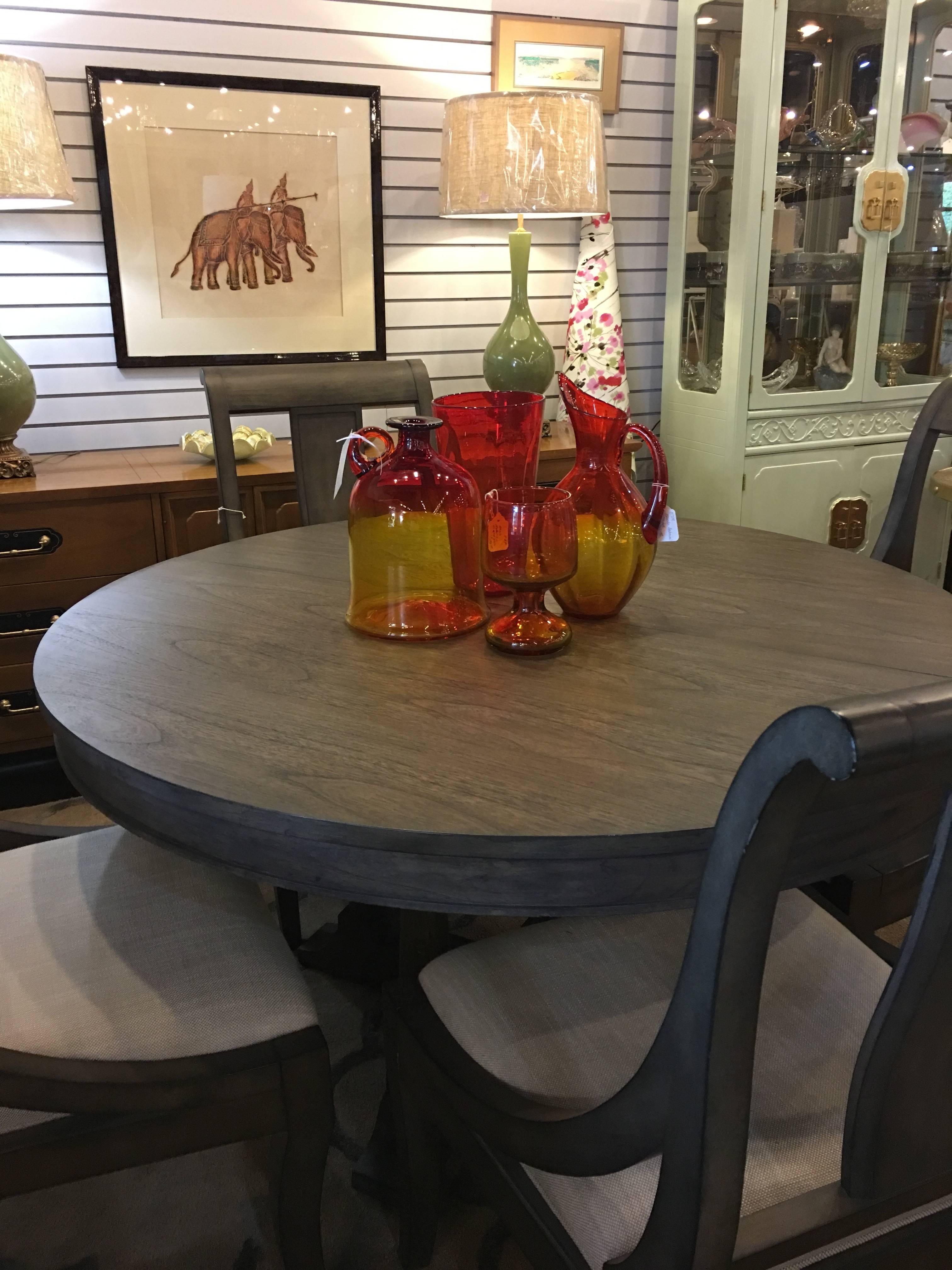 This very sturdy set is by Hekman and is very well built and heavy. The table has a 20 inch; leaf which increases it size to 74 inches large enough to easily seat eight. The diameter without the leaf is 54 inches, making it a perfect dinette table,