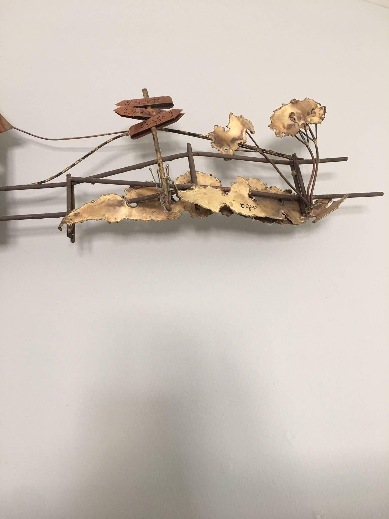 Period 1970's Brutalist wall mount sculpture of a covered bridge, complete with road sign, cat tails, birda on the roof, and plantings.  This intricate piece by C Jere is a gem.  The interior of the piece is painted a distressed red.  You will