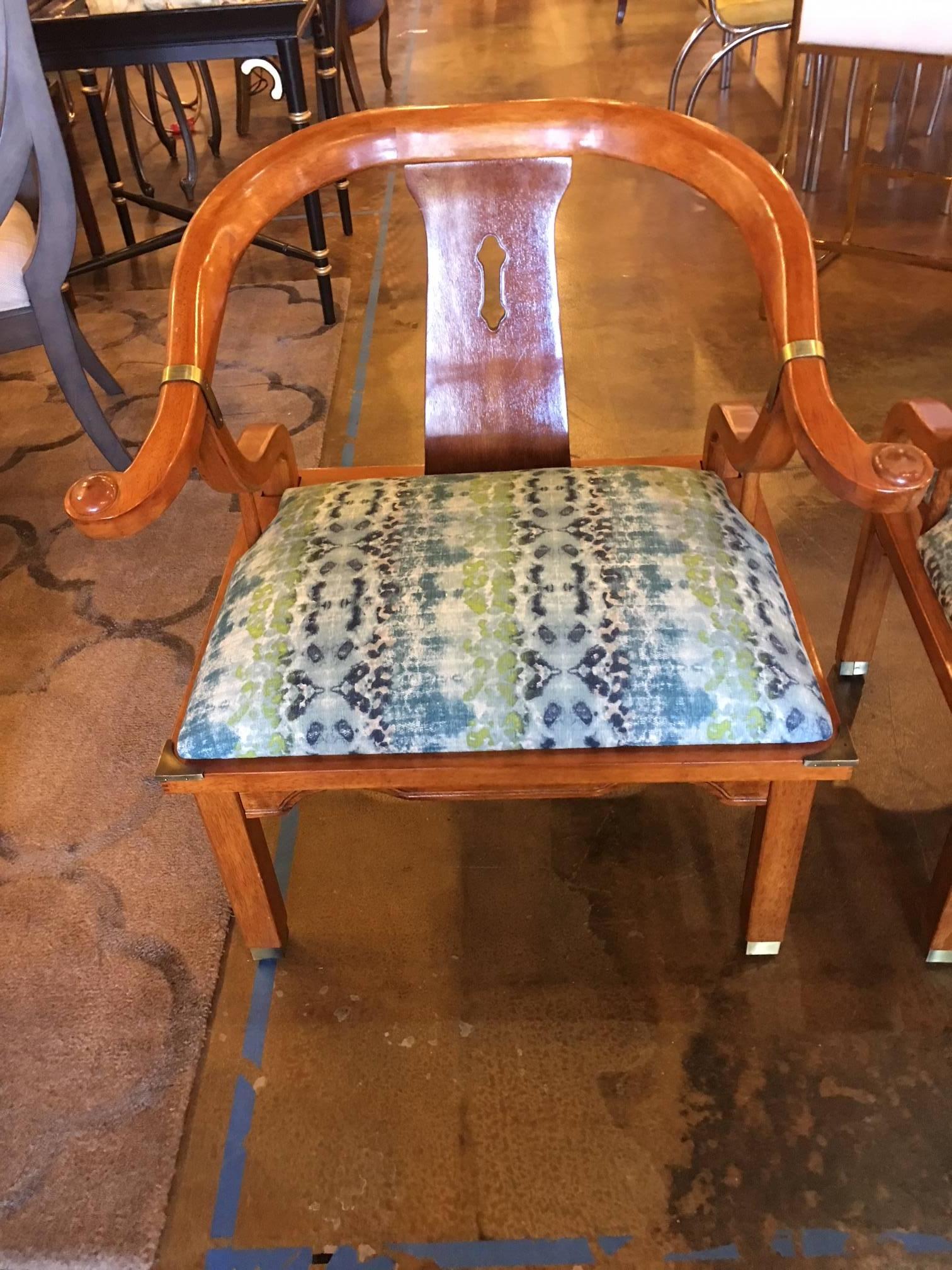 These chairs are by Century, but closely resemble James Mont's horseshoe chairs in the style made famous by James Mont. They have been newly reupholstered in a heavy contemporary linen like weave in shades of blue and green. You often see these
