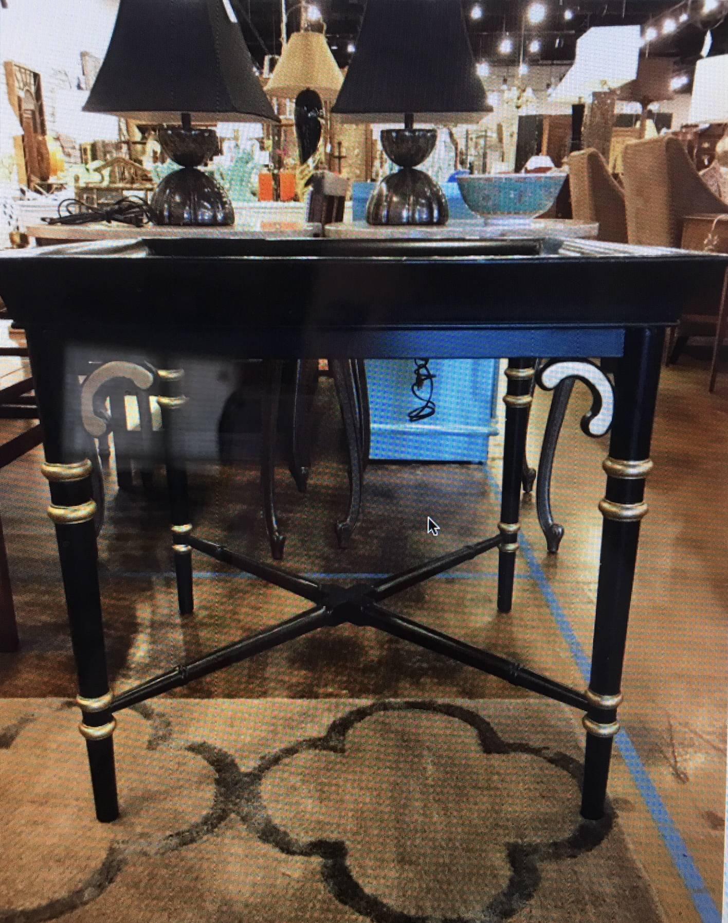 This table is vintage Maitland Smith and is a bit of an unusual size. It has been professionally lacquered in a satin finish with gilded accents. Could be used as a corner table with sofas flanking it, an end table, or a tea table. Glass insert top