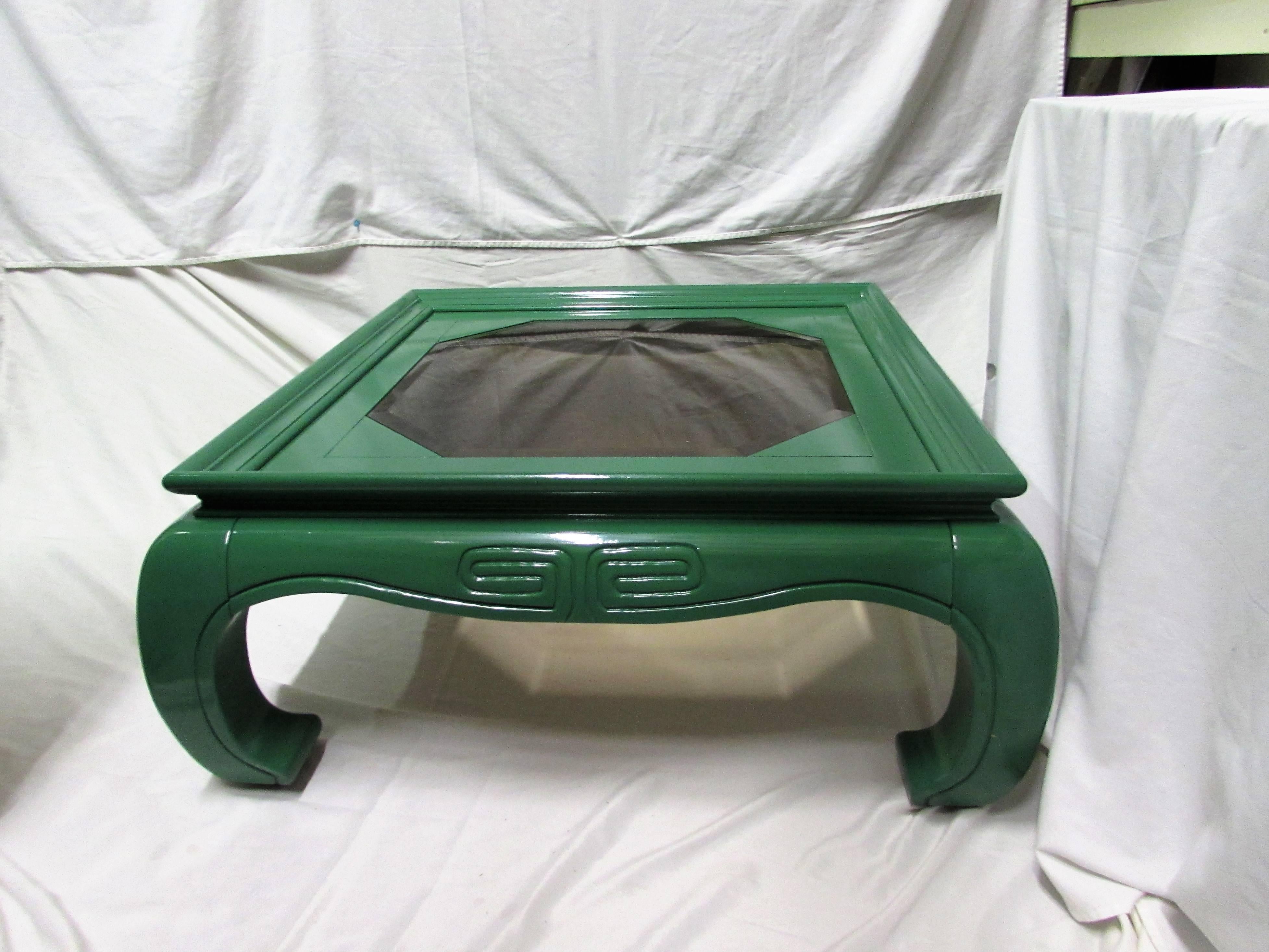 Greek Key motif coffee table with Ming-style legs and smoked glass on top. Newly lacquered in a high-gloss green finish.
