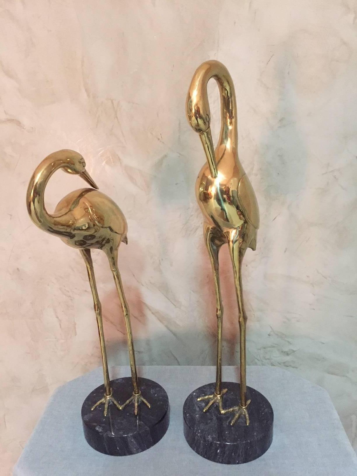 Elegant French brass Heron couple on a marble base. Nice neck curves.
Very good condition. The brass is very shiny and give the impression that it is gold. 
This couple might be perfect as a decoration on a living room buffet.