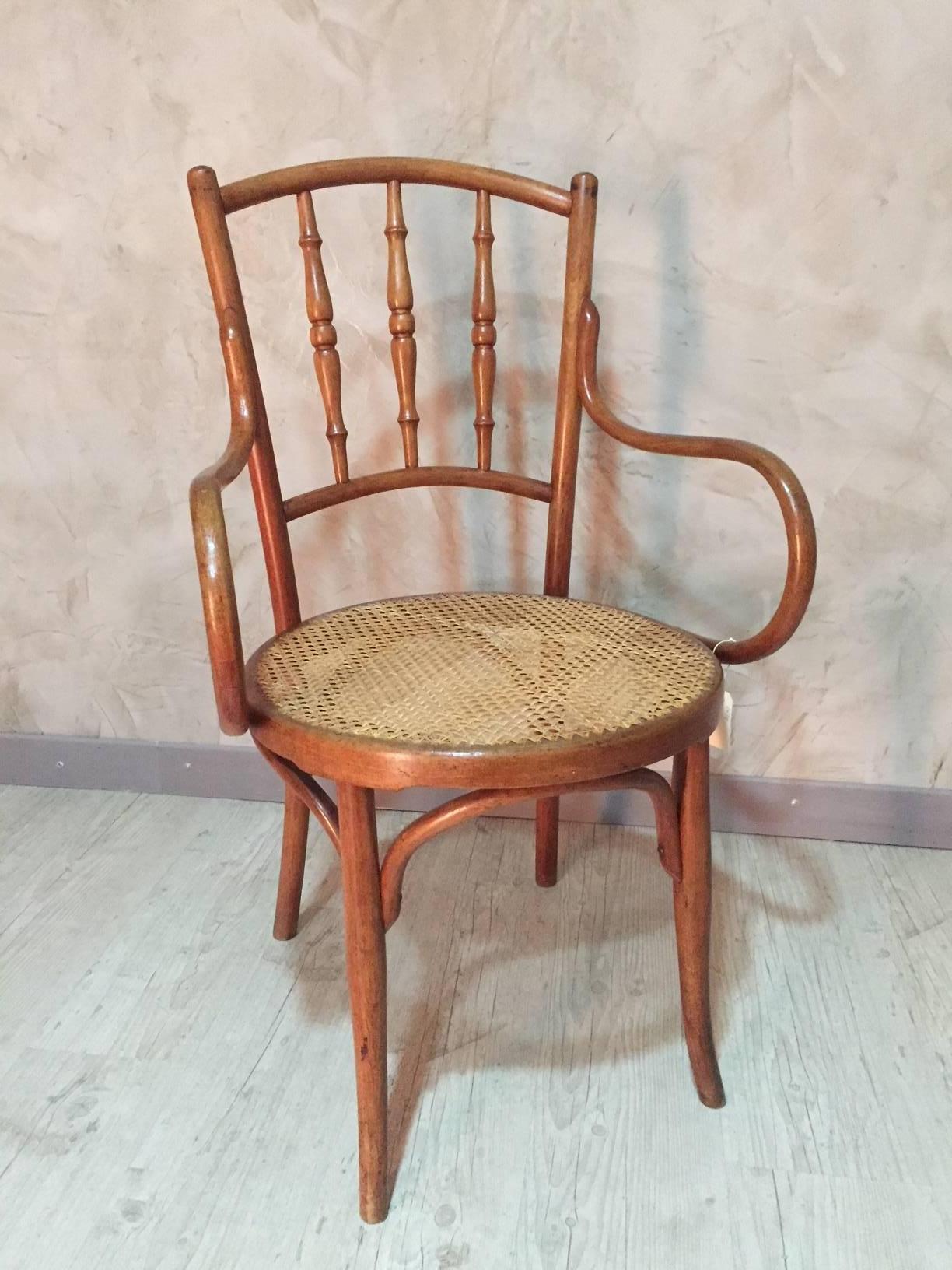 Armchair by Josef & Jacob Kohn. There were well known for being one of the first to work curved wood. 
This armchair is cane on the seat and in a good condition. It would be ideal for an office.