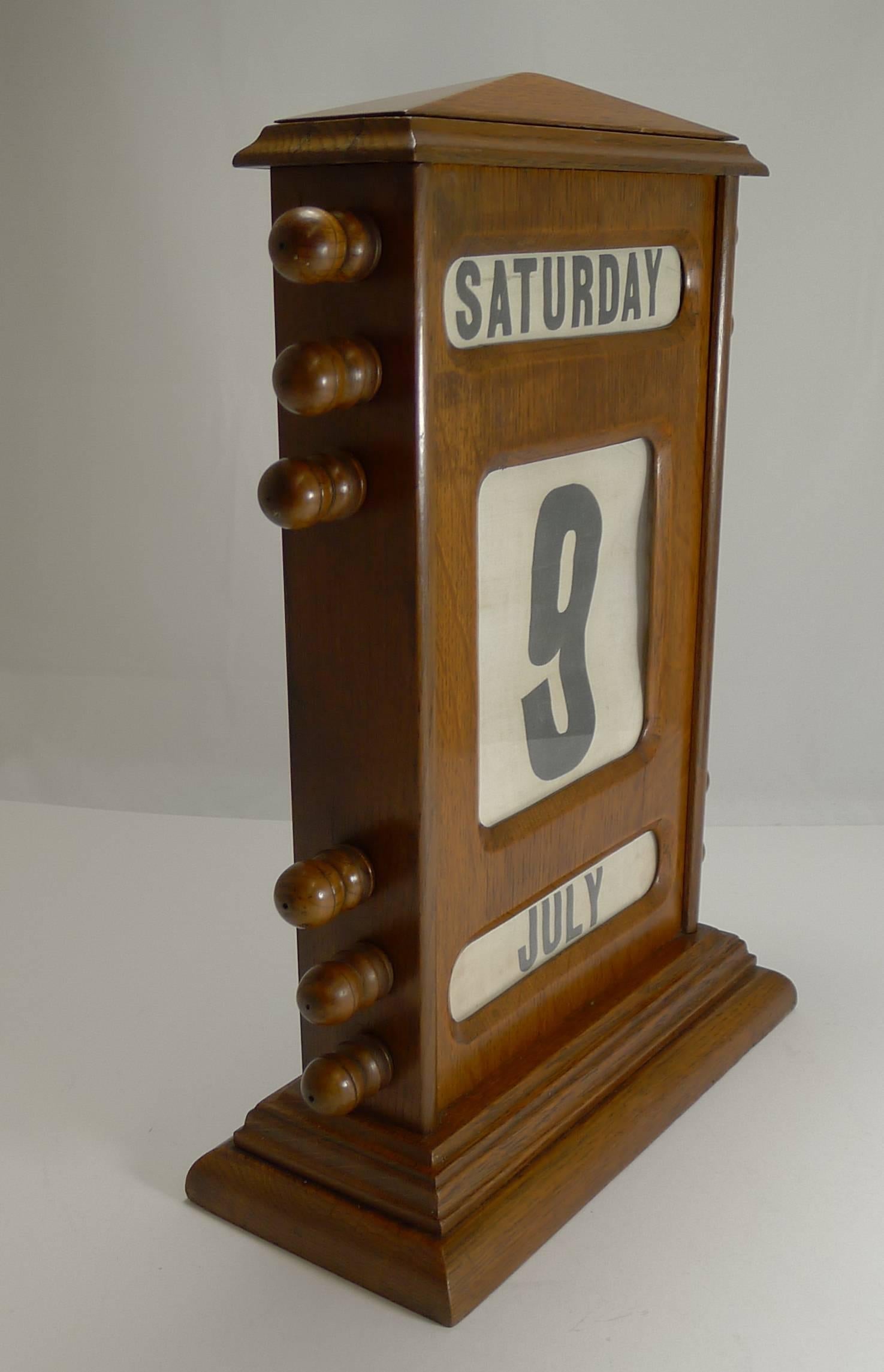 A rare and early example of a desk-top perpetual calendar, this one dating to the late 19th century, circa 1890.

Made from solid English Oak, this impressive oversized example stands a very grand 15 1/2