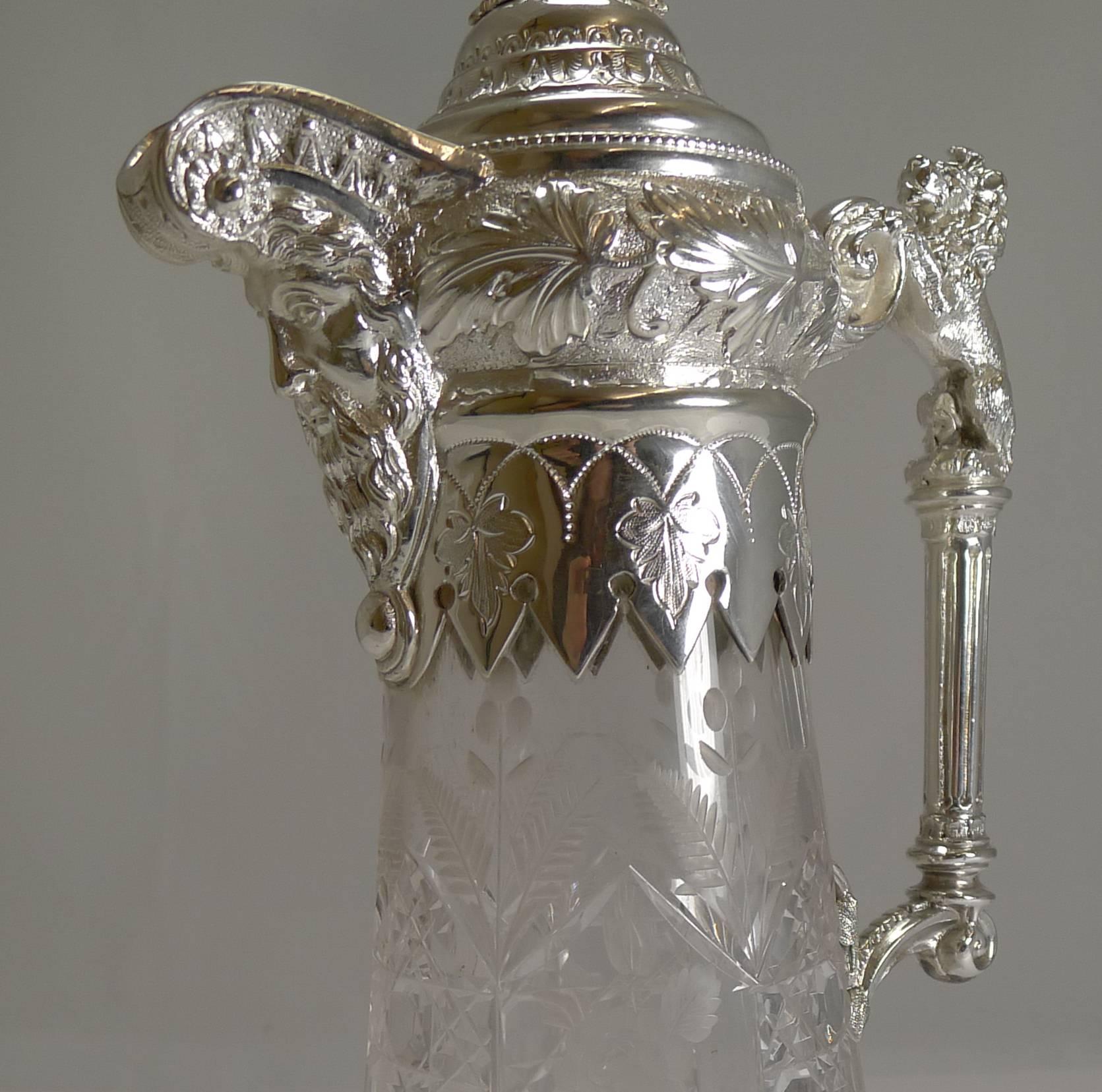 A fabulous and highly decorative Claret jug, made from English crystal with alternate panels of wheel engraved floral and folate vignettes and deep hobnail cut panels.

The silver plated fittings are a joy, very grand looking with the top of the