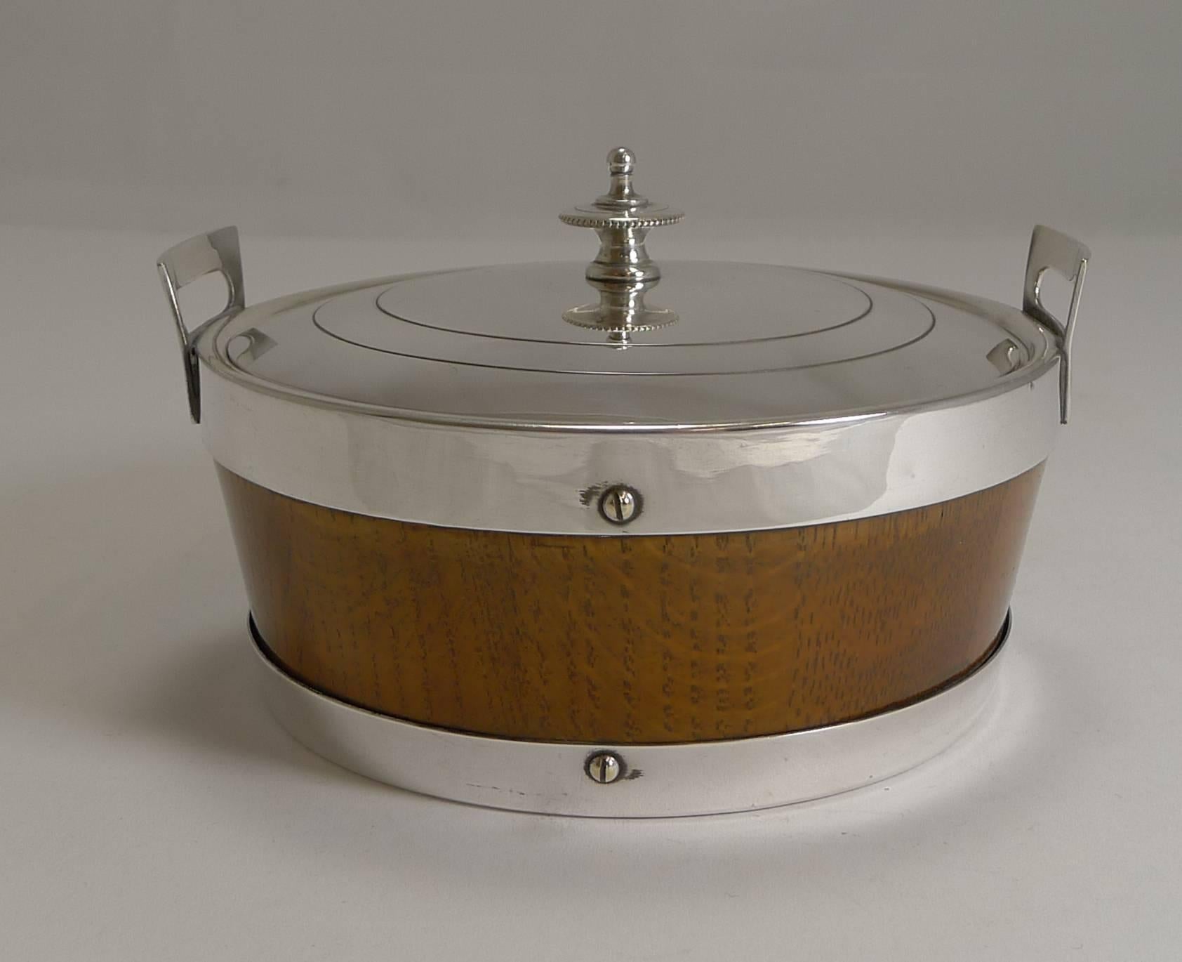 A handsome late Victorian butter dish in the winning combination of solid English oak with silver plated mounts.

The lid lifts to reveal the original cream ware ceramic liner which of course is removable, The underside of the lid marked EPNS for