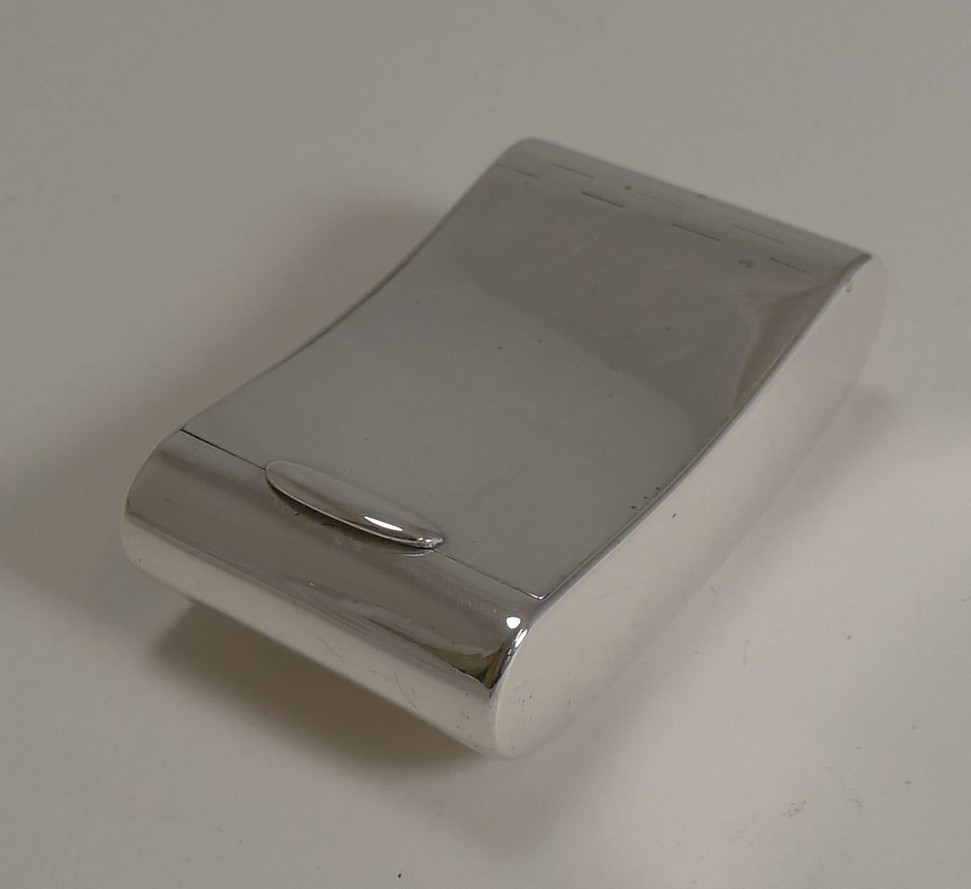 A very smart and very elegant kidney shaped vesta case or match striker made from a heavy gauge of English sterling silver.

The lid fits perfectly and the beautifully engineered flush hinge can be seen from the lid. Once the lid is opened, the