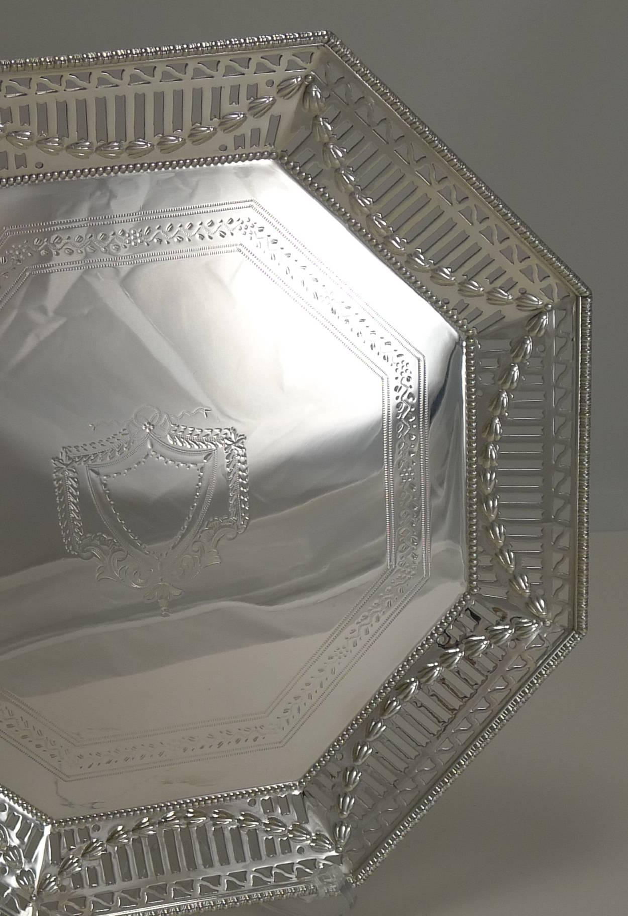 An unusual and highly decorative Edwardian silver plated salver or tray dating to circa 1900-1910.

The unusual octagonal shape is decorated with a pierced or reticulated border overlaid with a continuous foliate garland, the centre is engraved