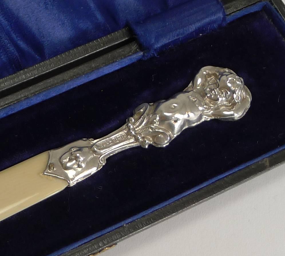 A charming Edwardian cased letter opener, complete with it's original presentation case.

The letter opener has a terminal in the form of a Cherub or Putti figure both back and front, fully hallmarked for Birmingham 1906 together with the makers