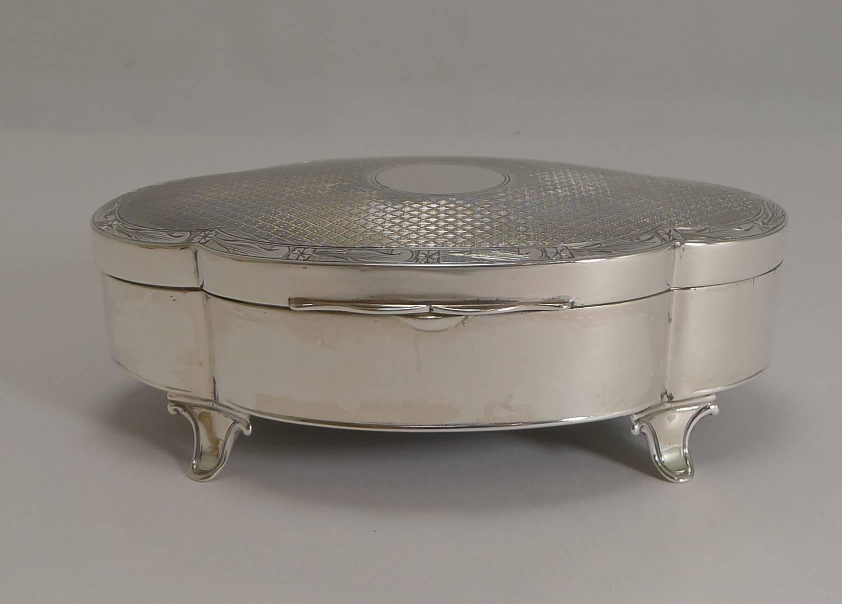 A beautiful and very elegant jewelry box made from English sterling silver by the top-notch silversmith, Goldsmith's and Silversmith's Company of Regent Street, London.

The box stands on four pretty feet and is beautifully shaped. The lid is