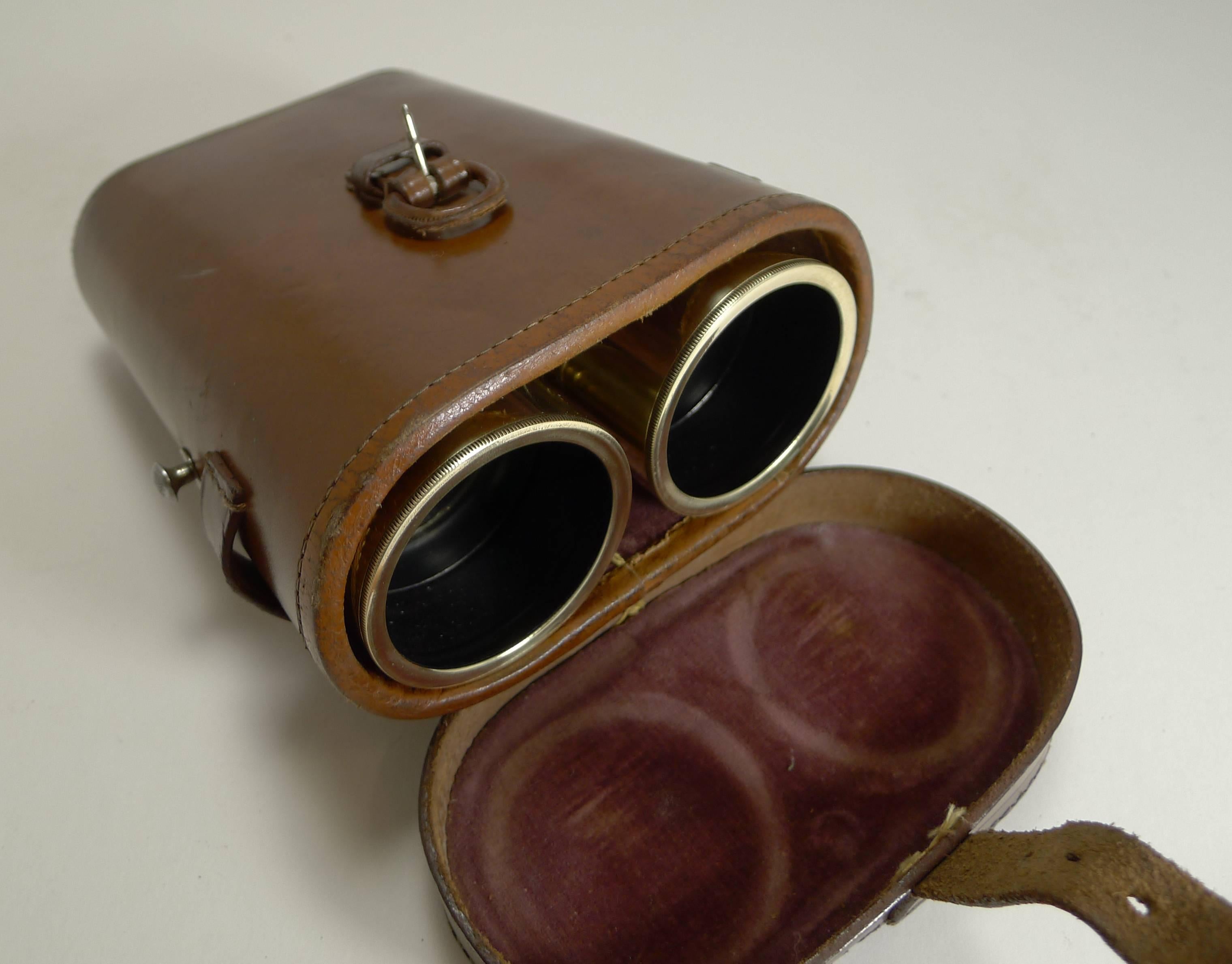 A handsome pair of British issued first world war leather and polished brass binoculars together with an excellent leather case. Possibly made in France, they were retailed in London by the famous Optician's 