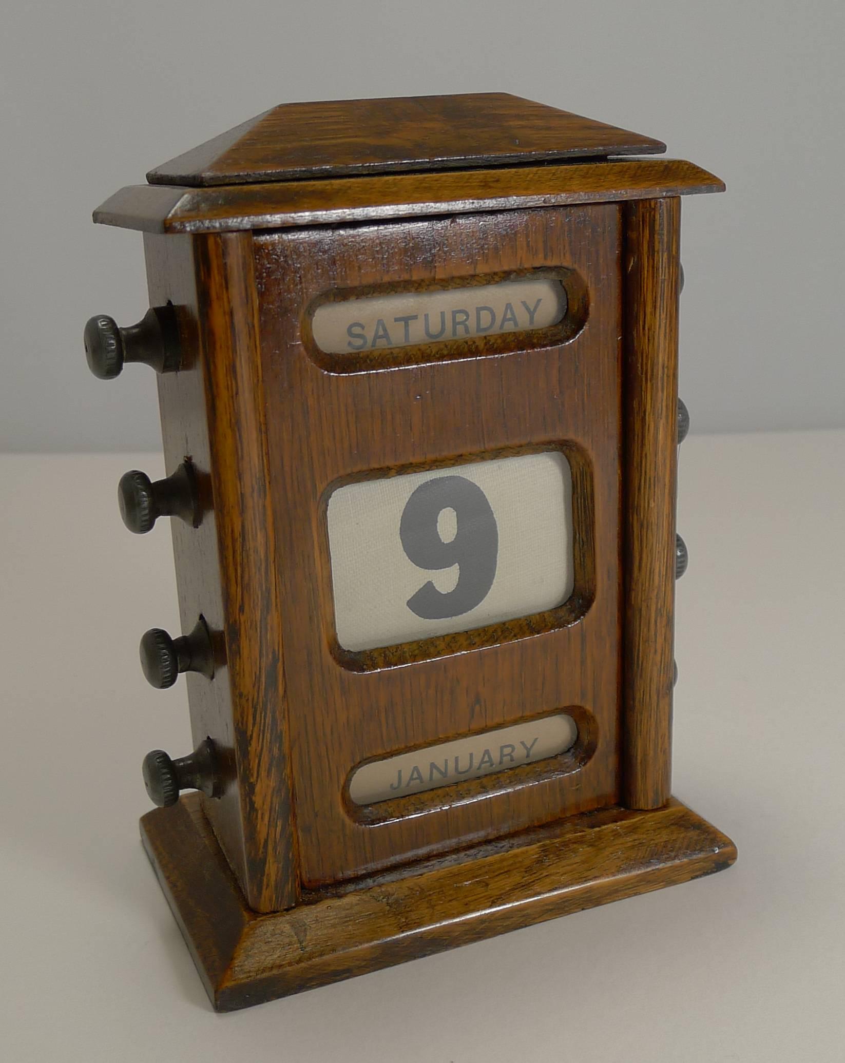 A most handsome English perpetual calendar made from solid English oak and dating circa 1900, late Victorian or Edwardian in era, this one beautifully polished and in great condition.

The four metal knobs to each side are used to move forward and
