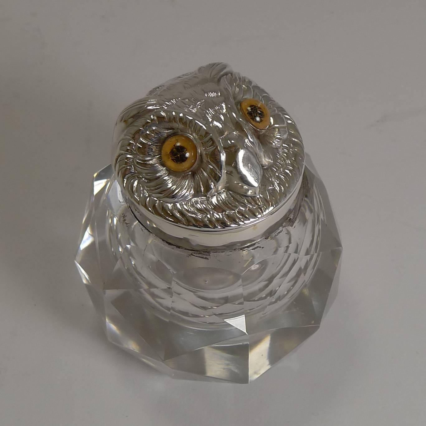 A charming late Victorian cut crystal inkwell with a sterling silver collar and hinged lid. The lid is in the form a an Owl's head retaining his two original glass eyes.

The collar has the makers mark together with an English design registration