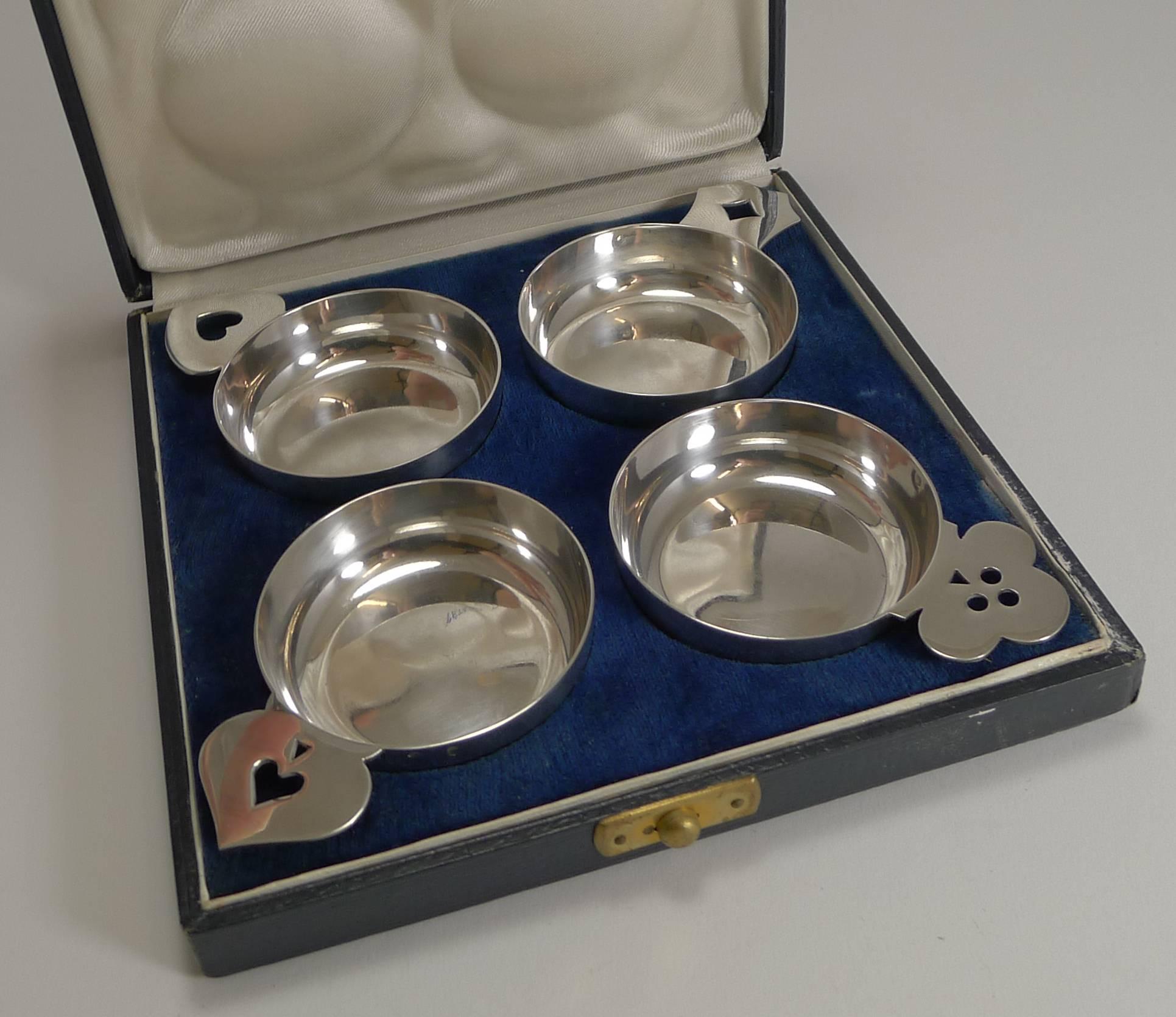 A charming set of four Art Deco French sterling silver wine tasters, all in superb condition each with a novelty shaped and pierced handle, all with a different playing card suite motif.

They come in their original presentation box, the lining of
