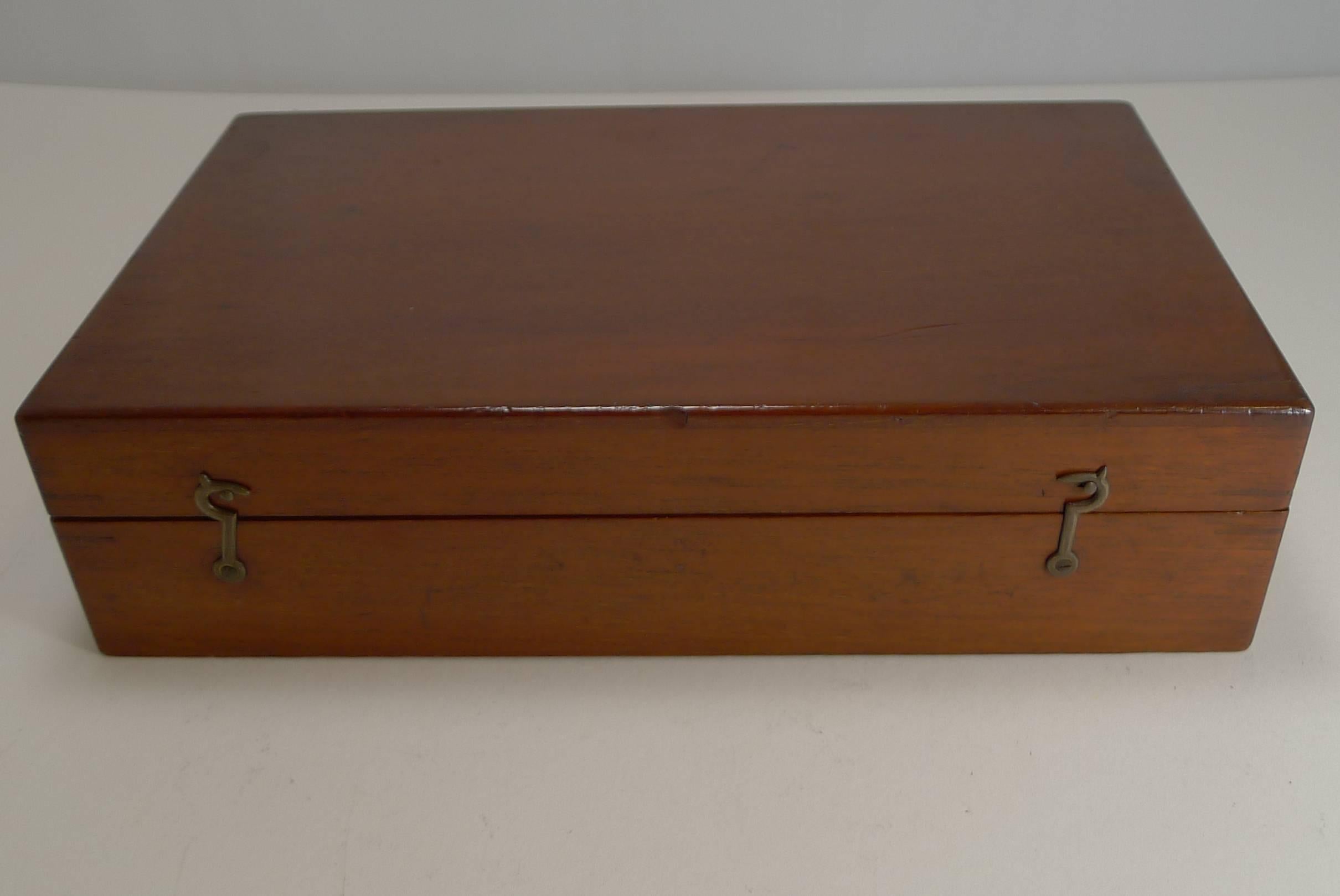 A fabulous Edwardian mahogany games box or compendium in fabulous condition. The box contains:

Three games boards: Chess / draughts / checkers; the race game and go bang. Original instruction booklet original gift card dated 1905 set boxwood and