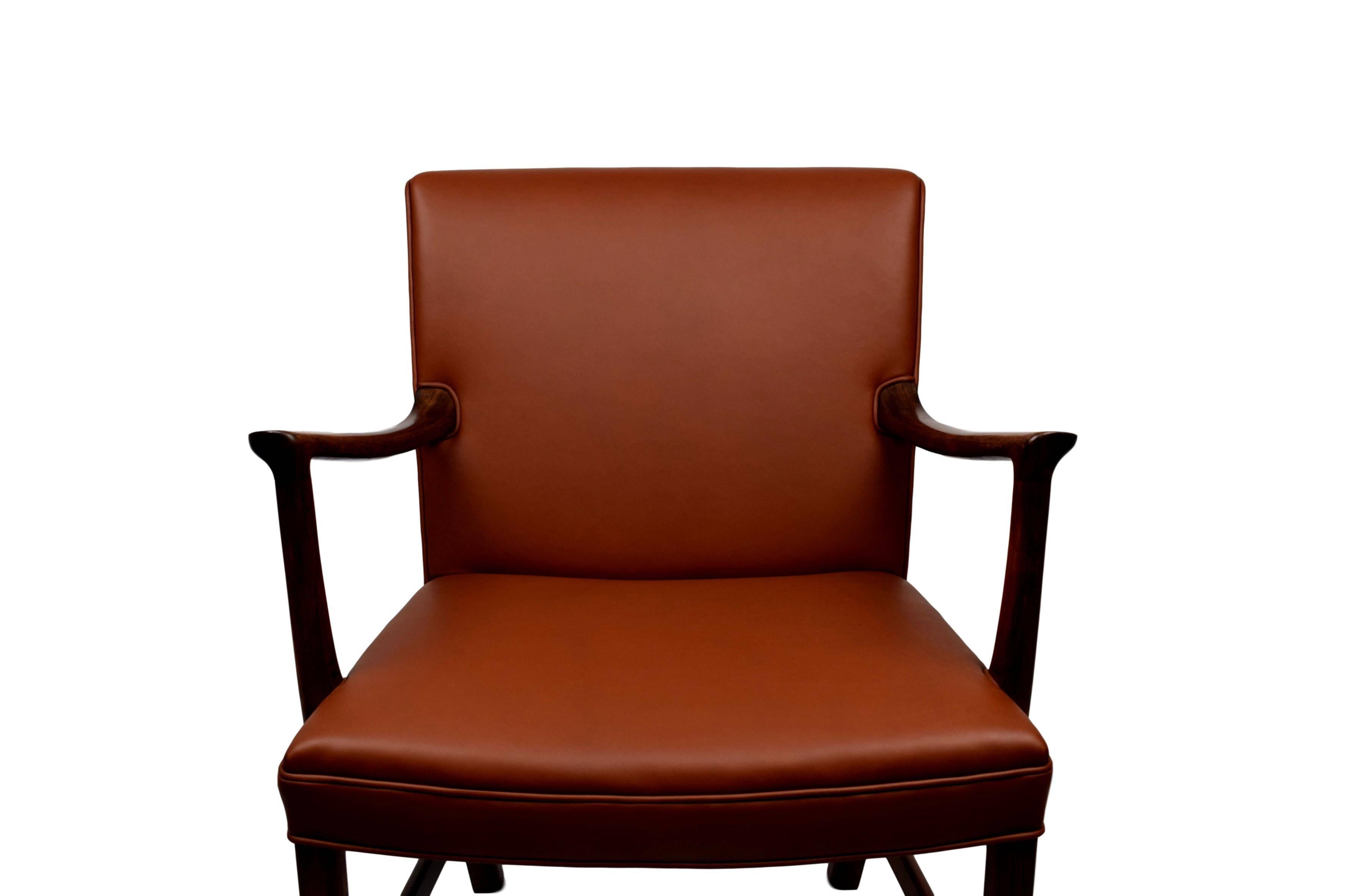 A Danish midcentury armchair newly upholstered with brown aniline leather. By Ole Wanscher (1903-1985). Rosewood frame. Produced by cabinet maker A. J. Iversen.

 