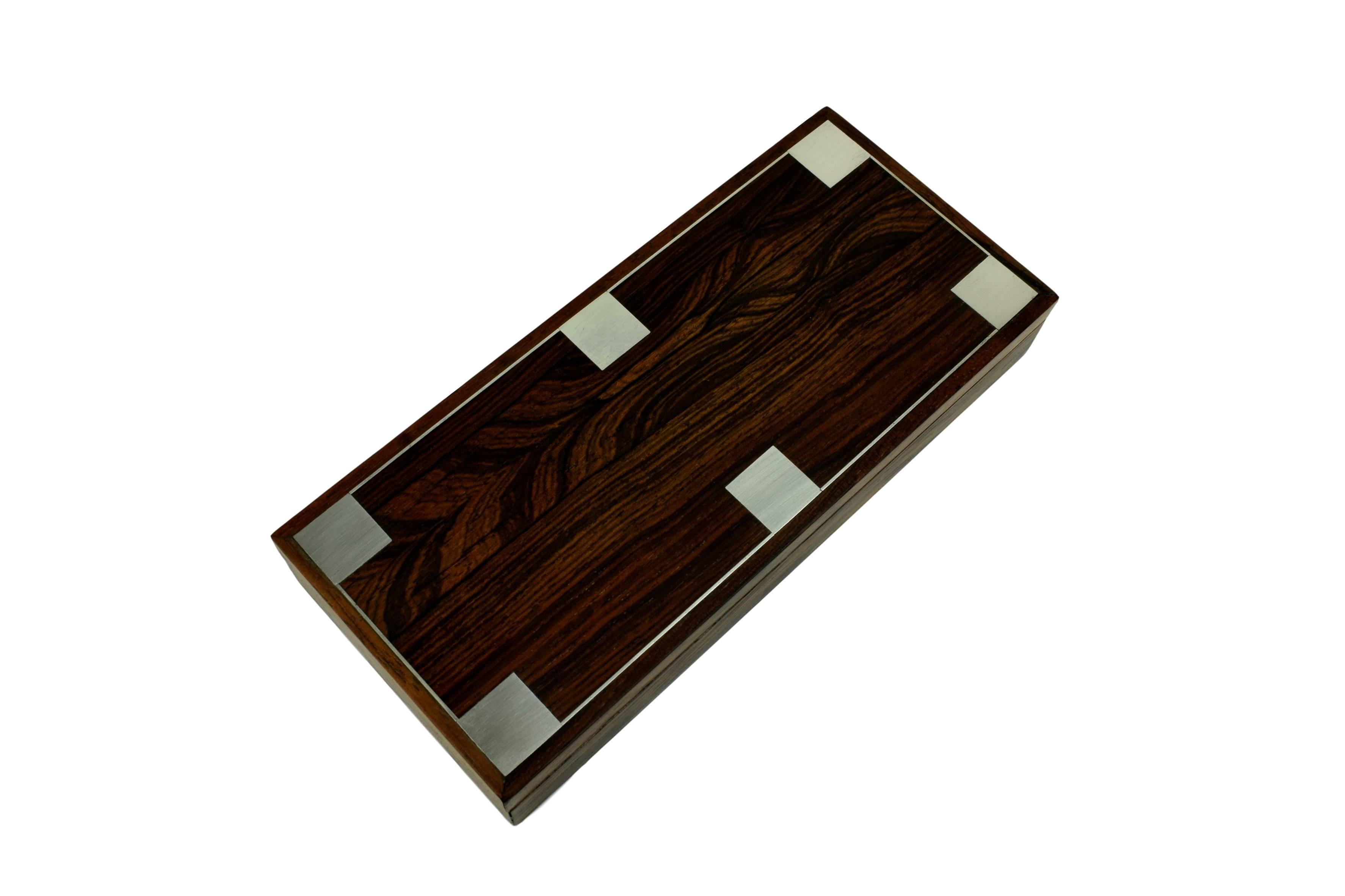A Danish midcentury rosewood box with six square Sterling 925 silver inlays. Design by Danish silversmith Hans Hansen. Two adjustable compartments.

Hall mark on the bottom of the box with the text 