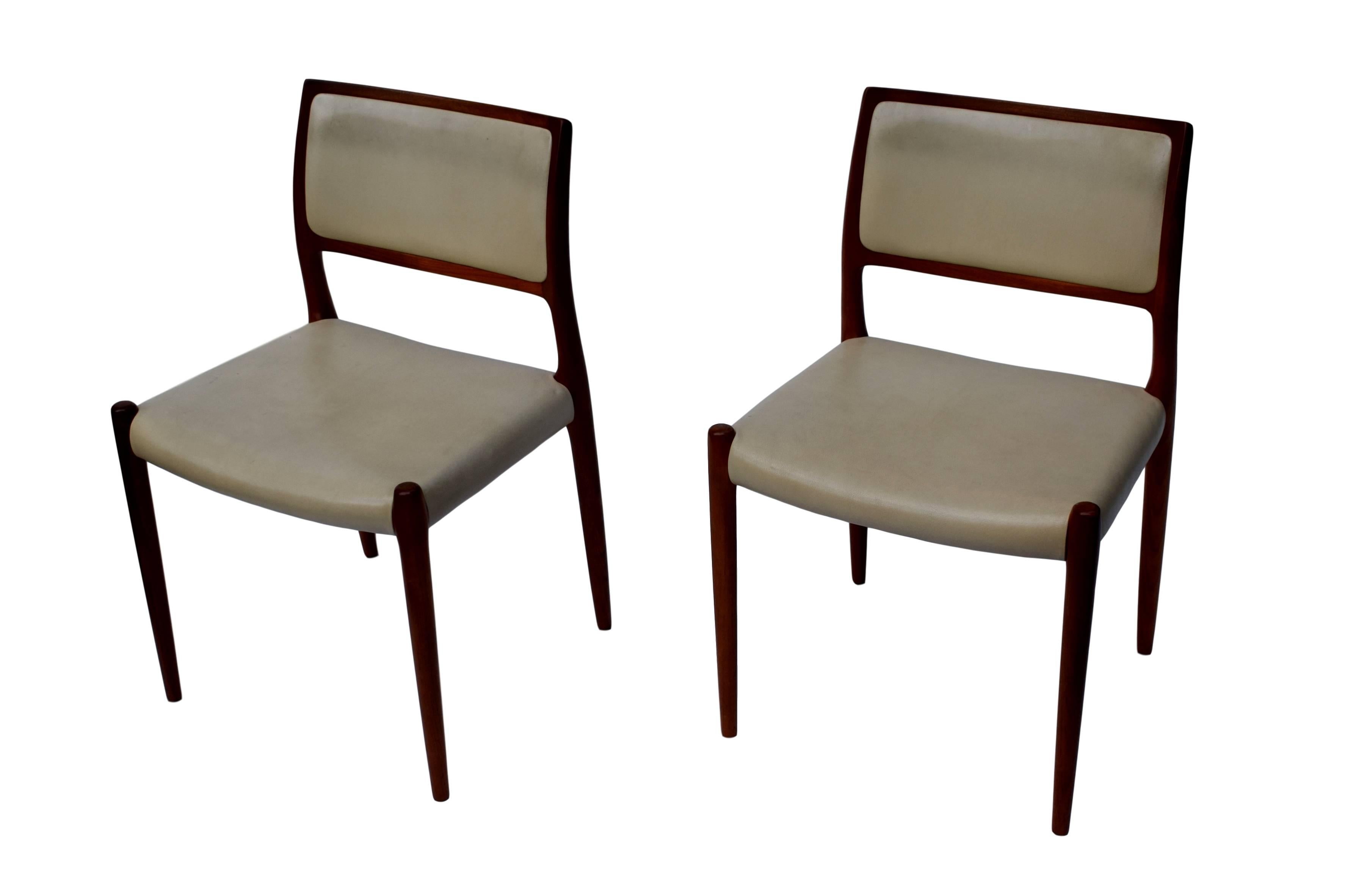 A set of four dining chairs by Niels O. Møller. Model 80. Teak frame with tapered legs. Design from 1968. The chairs are upholstered with patinated beige leather. Produced by J.L. Møller Møbelfabrik. Stamped with 