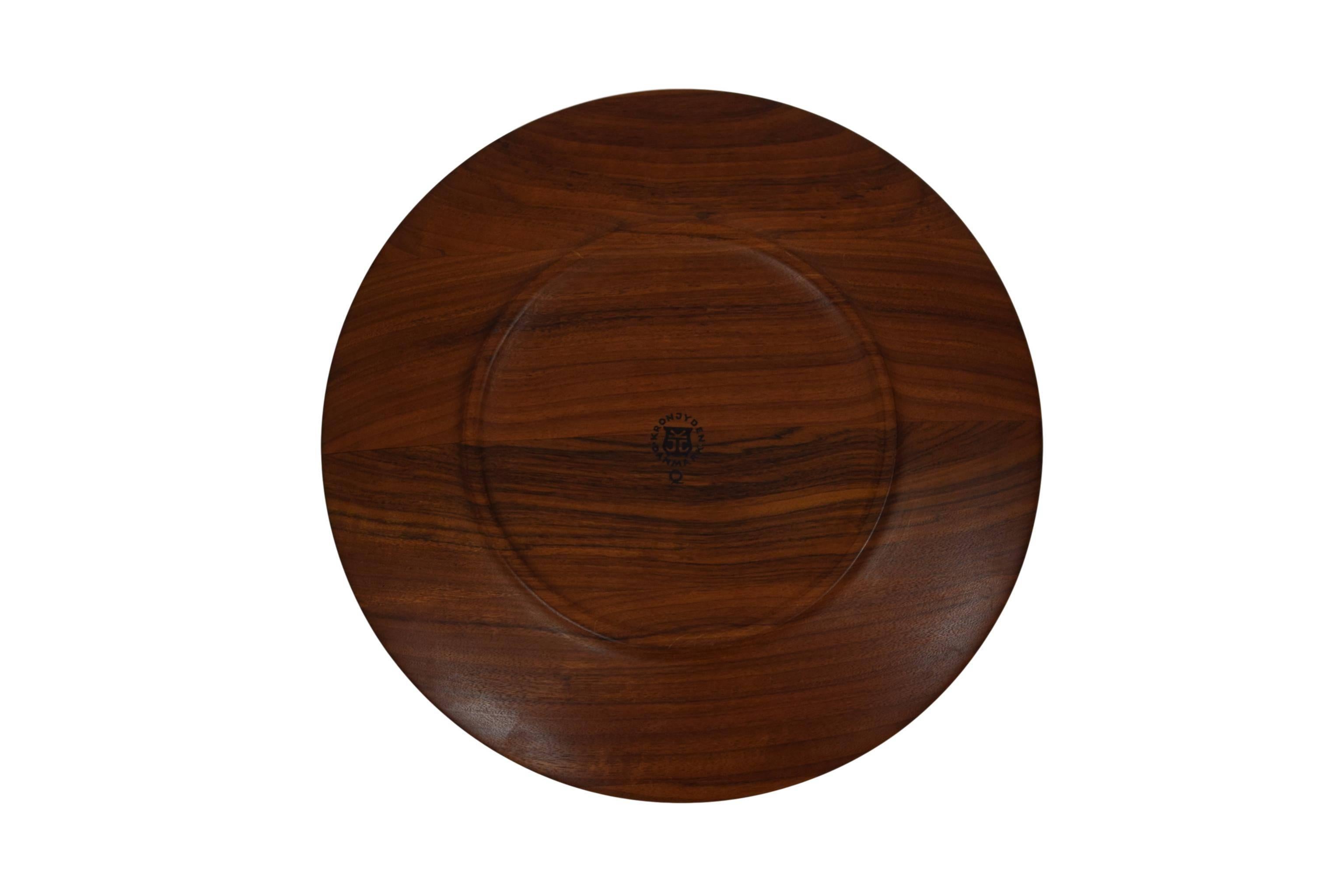 A Danish midcentury cover plate by Jens Harald Quistgaard (1919-2008). Produced by Kronjyden. Made from teak.

Stamped 