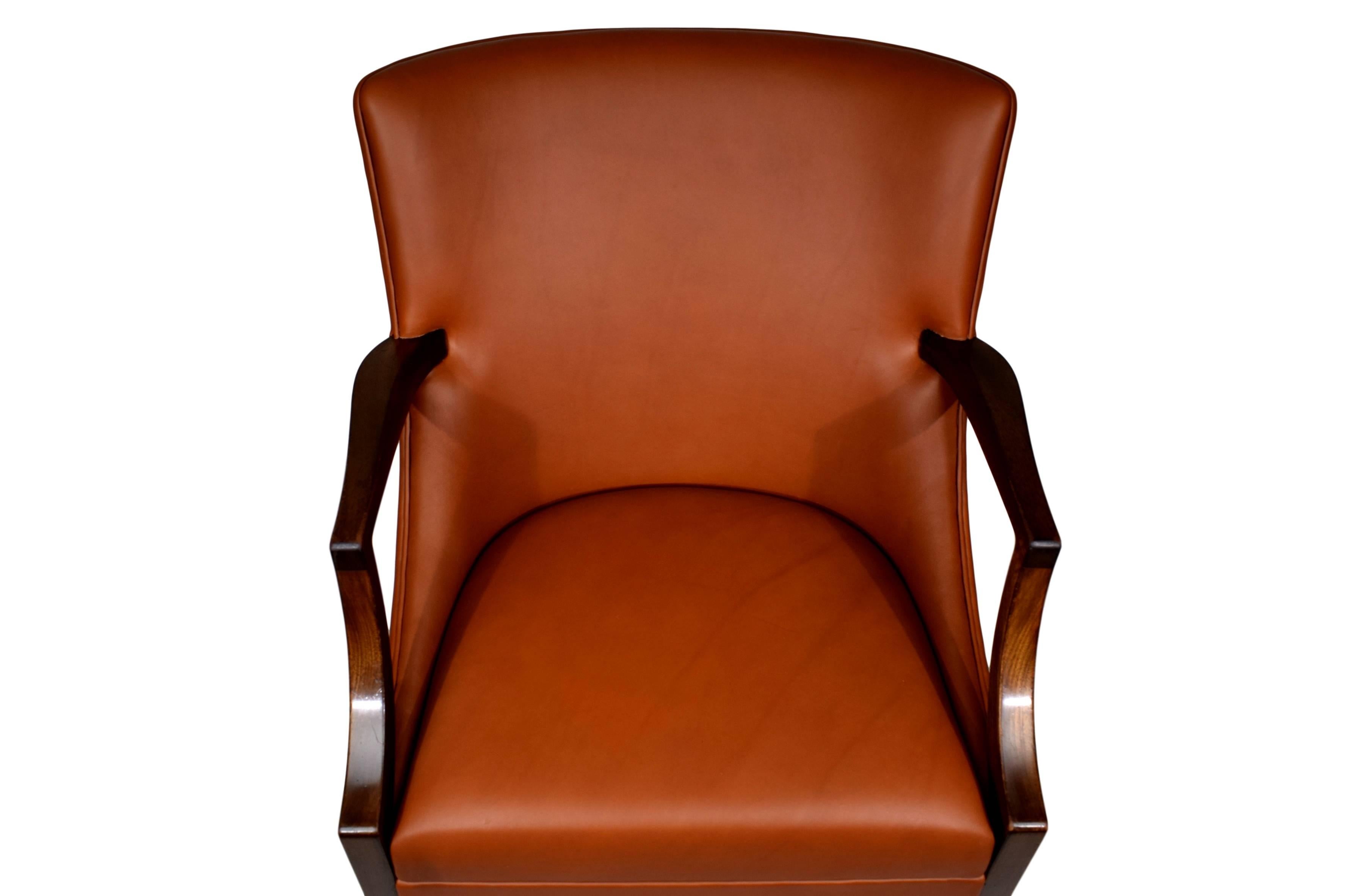 A Danish midcentury mahogany armchair by Ole Wanscher (1903-1985). Produced by cabinet maker A.J. Iversen. The chair is newly upholstered with brown full-grained, vacuum-tanned, smooth aniline leather.


   
