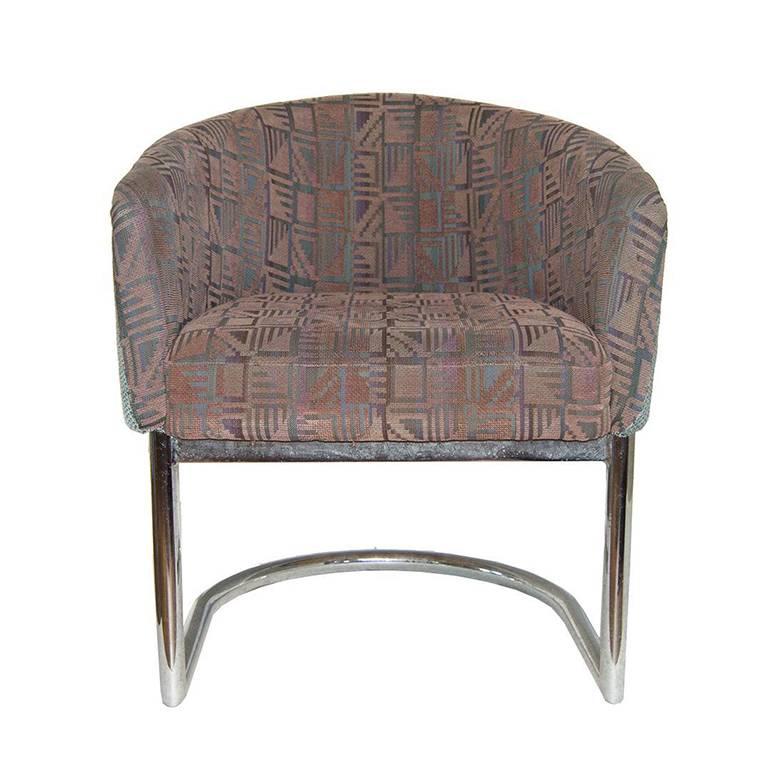 Midcentury retro barrel chair in the style of Milo Baughman. This piece features a tubular cantilever chrome base. The pattern is a fun southwest geometric print on the inside of the chair and blue around the back.