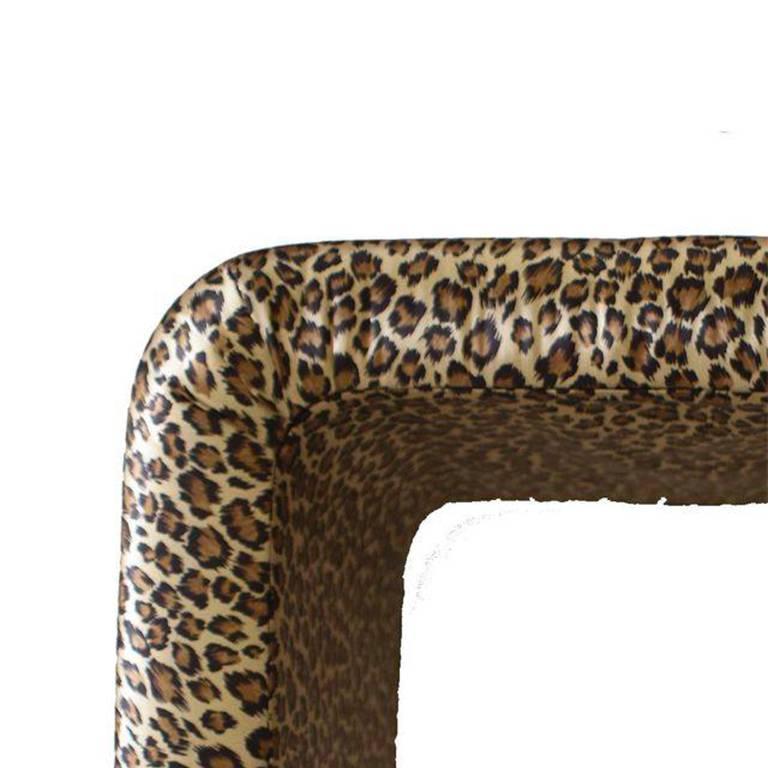 This gorgeous leopard print bench in the style of Milo Baughman is such a stunner! Covered in a silky leopard print, this piece would be wonderful as a vanity seat, in a bedroom, a closet or as extra seating in a sitting or living room. Could even
