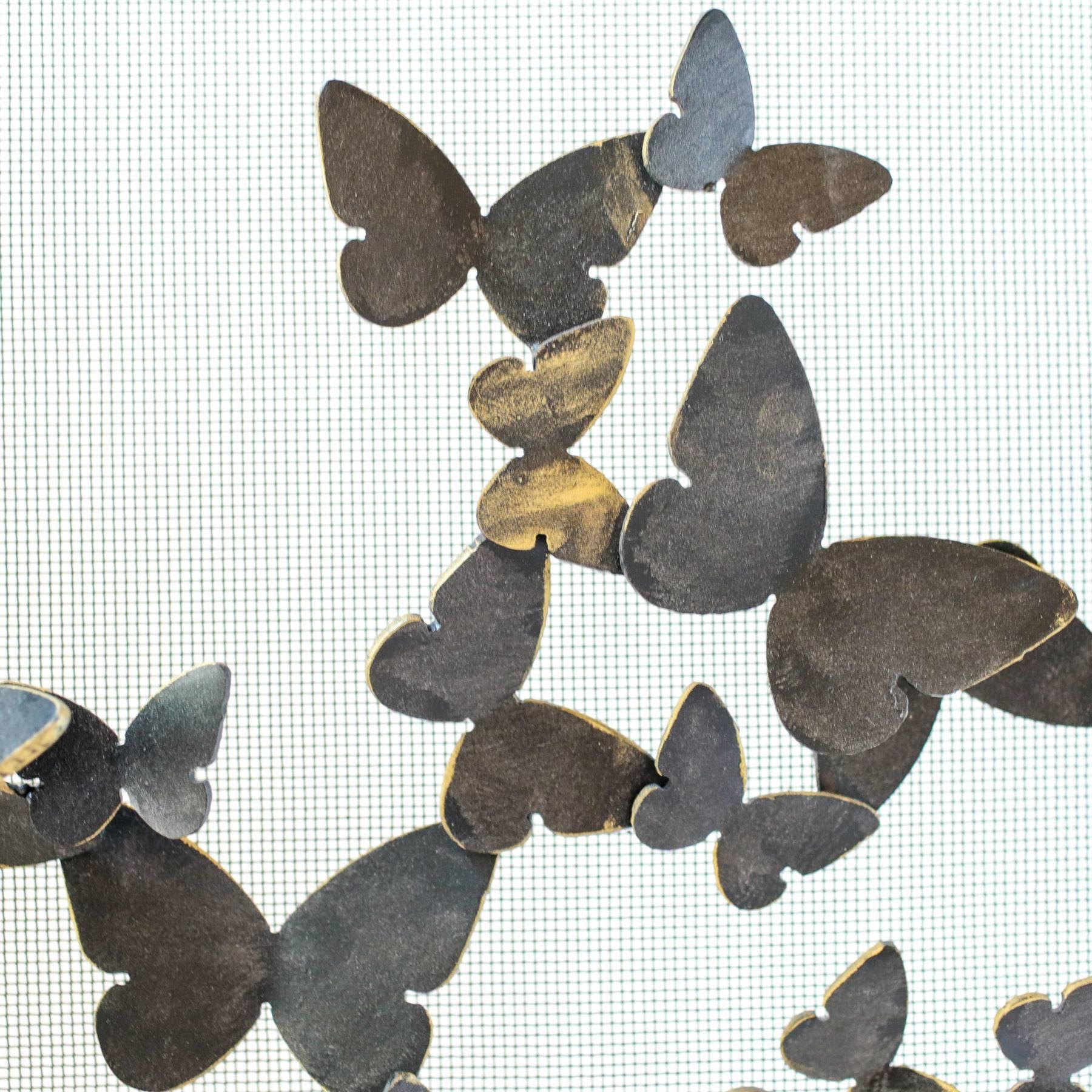 Fire screen or spark guard is hand-wrought iron shown in blackened gold finish. A flurry of butterflies scatter across a mesh backing, ideal for catching sparks from a wood-burning fire. This listing is for a made-to-order butterfly fireplace screen