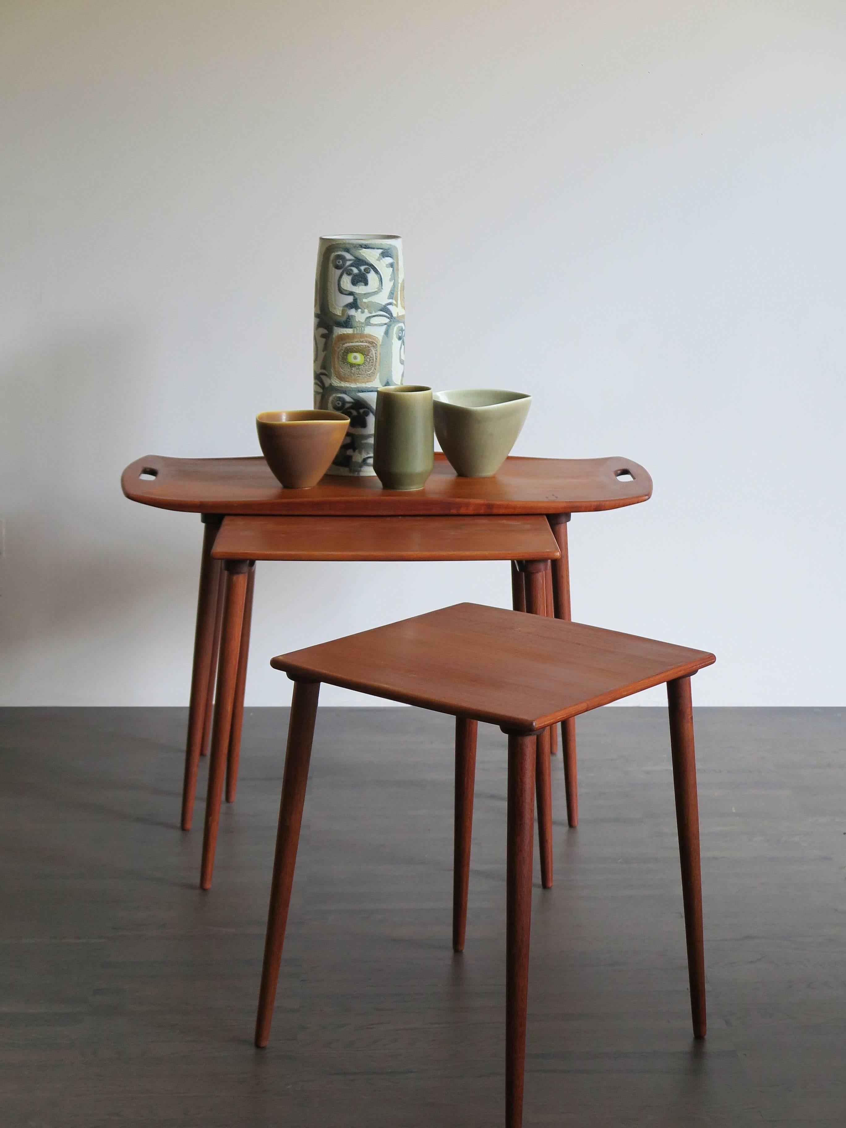 Famous and very rare set of three Danish teak nesting tables with a tray top designed by Jens Harald Quistgaard and produced by Nissen from 1960-1969.