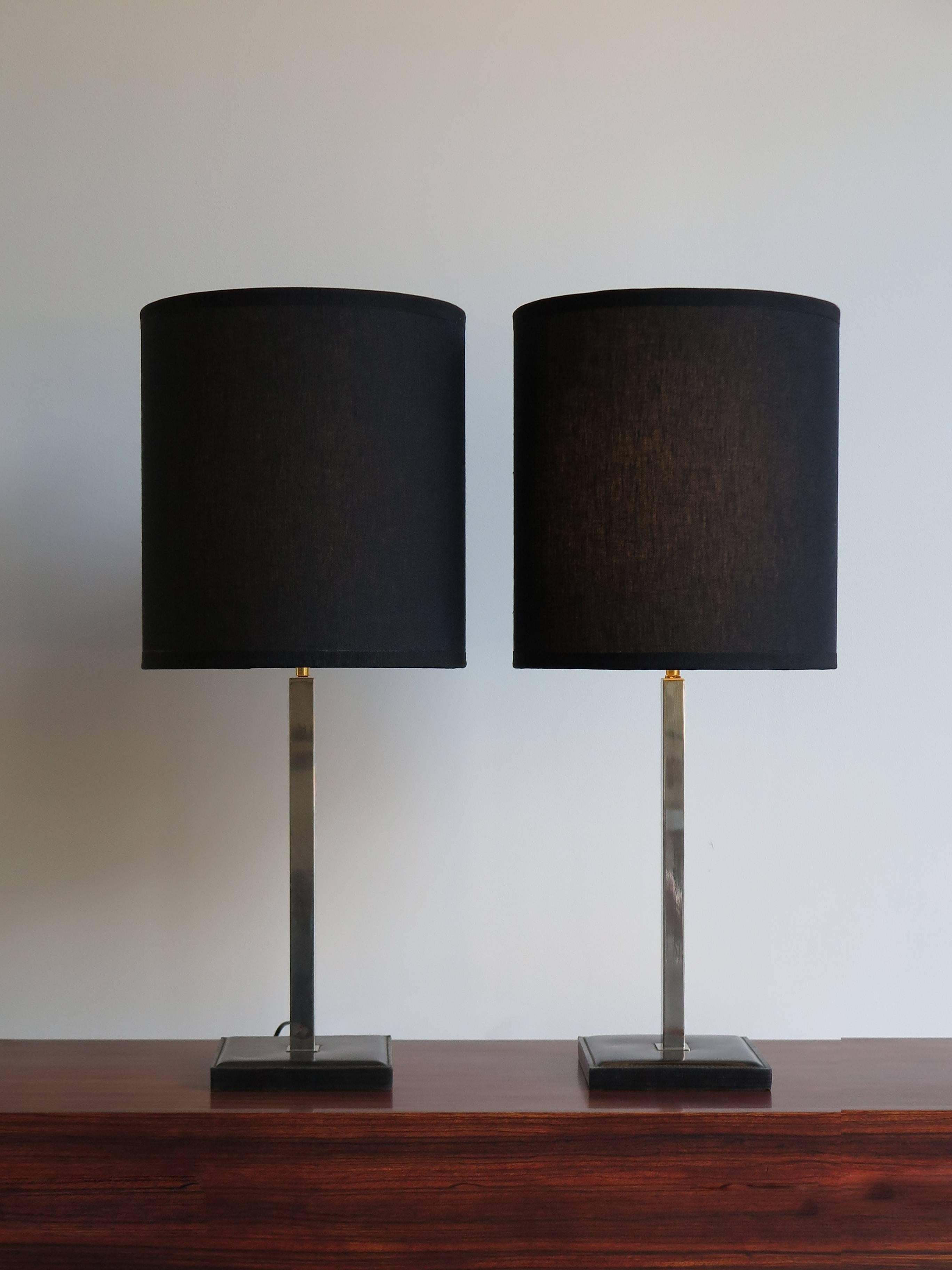 1960s couple of table lamps designed by Delvaux and manufactured in Belgium with
leather base, chromed structure and orientable new black fabric lampshade.