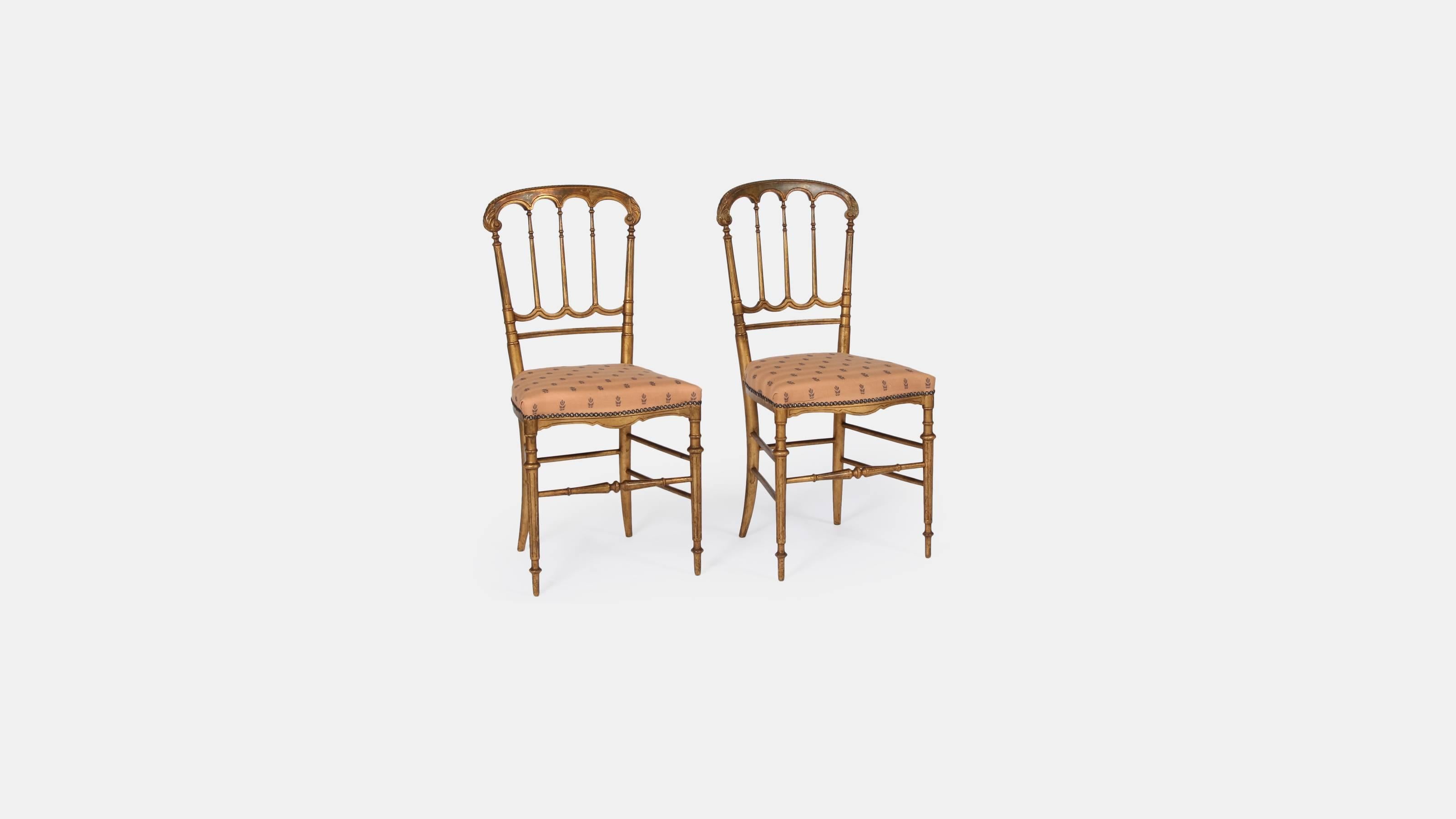 A pair of antique giltwood salon chairs, on slender tapering supports.

Each chair has beautifully aged gilding that has a fantastic patina look. The seat pads have been recovered with an antique embroidered cotton fabric.