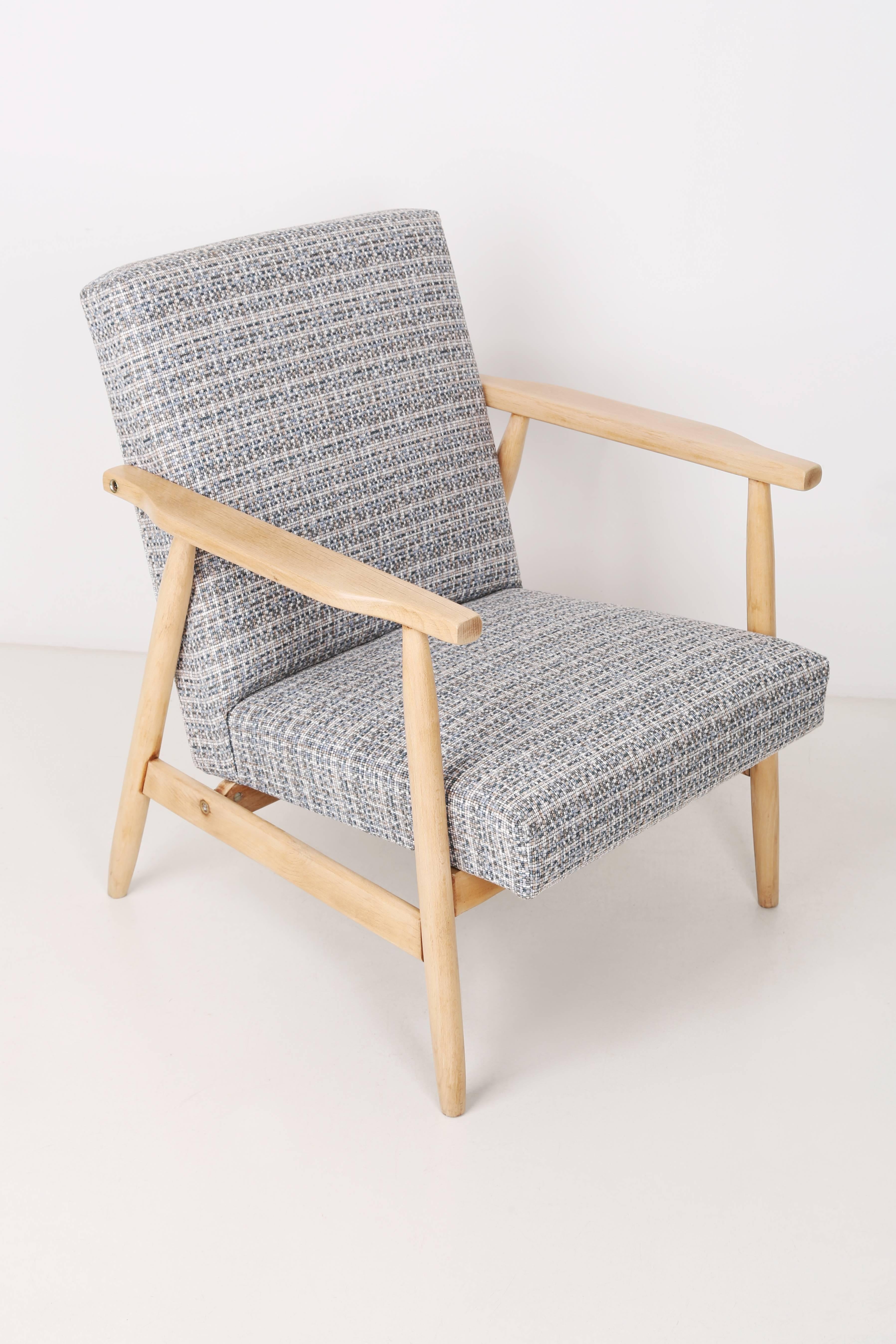 A very comfortable, stabile chair designed in the 1960s. It was made in Poland. The armchair is after full professional upholstery and carpentry renovation. The seat is covered with high quality fabric with a small pattern. We can prepare this