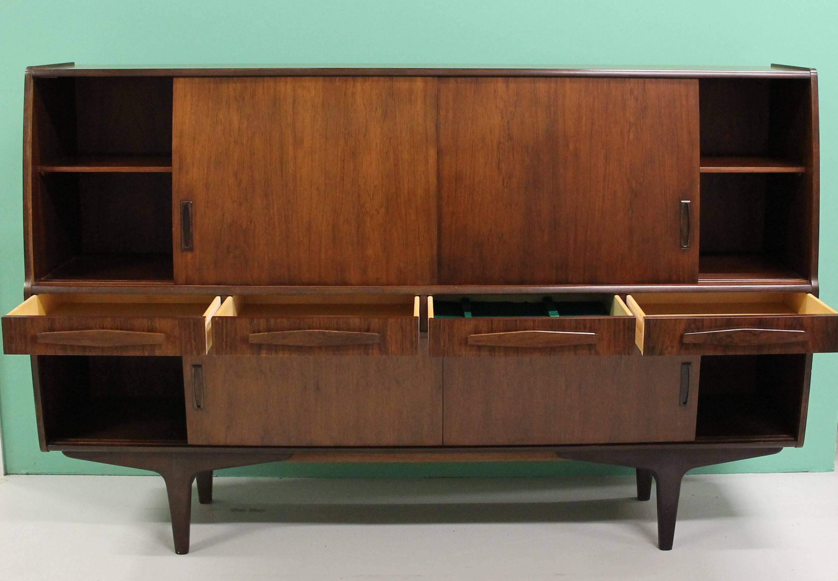 Denmark, 1950

1950s Poul M. Jessen rosewood sideboard, front with four drawers and six sliding doors.
 
Drawers include beautiful cutlery drawer.
Behind the upper sliding door you will find the cocktail bar and two extra drawers.
