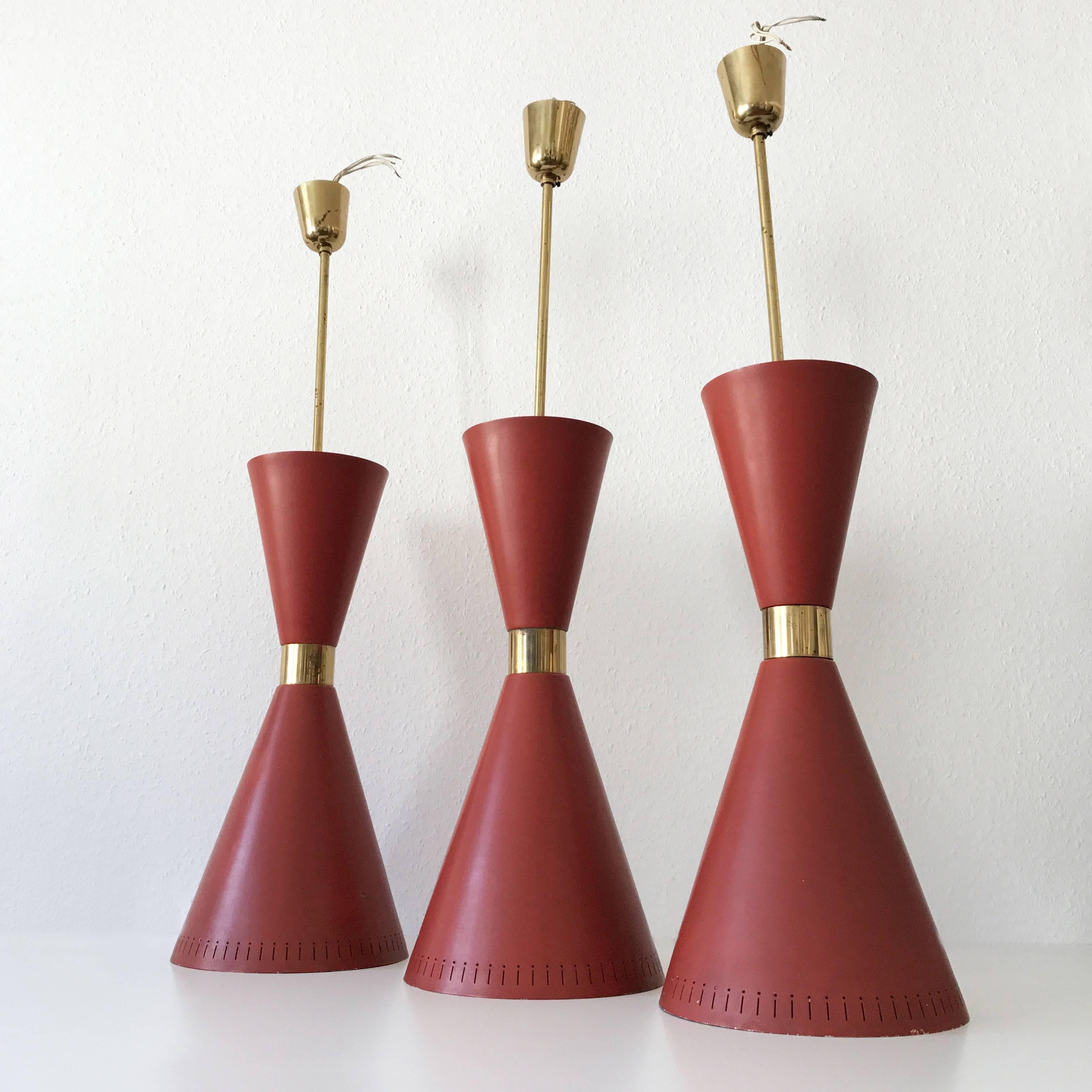 Set of three extremely rare and large diabolo pendant lamps or hanging light with perforated aluminum shade in dark red / bordeaux color. Manufactured probably by BAG Turgi, Switzerland. Originals from 1950s. 

Executed in perforated and in dark red