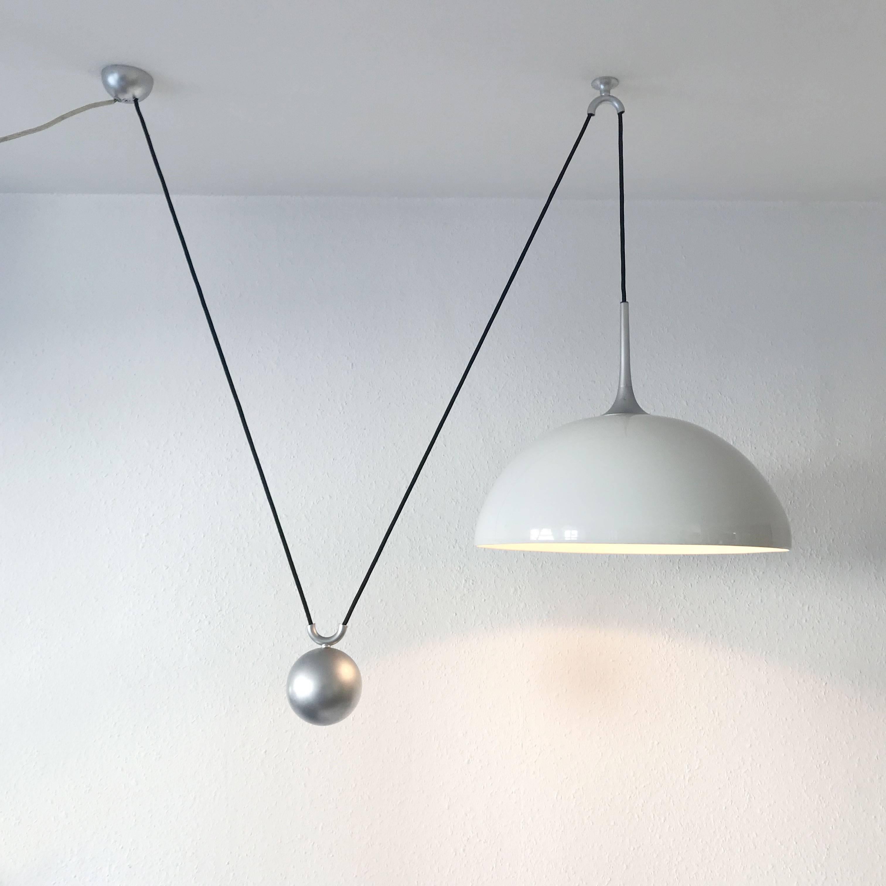 Counterweight pendant lamp by Florian Schulz, Germany. Executed with nickel-plated brass and porcelain lampshade. The lamp needs one E27 Edison screw fit bulb. Adjustable total height (the cord is 78.74 inch / 200 cm).