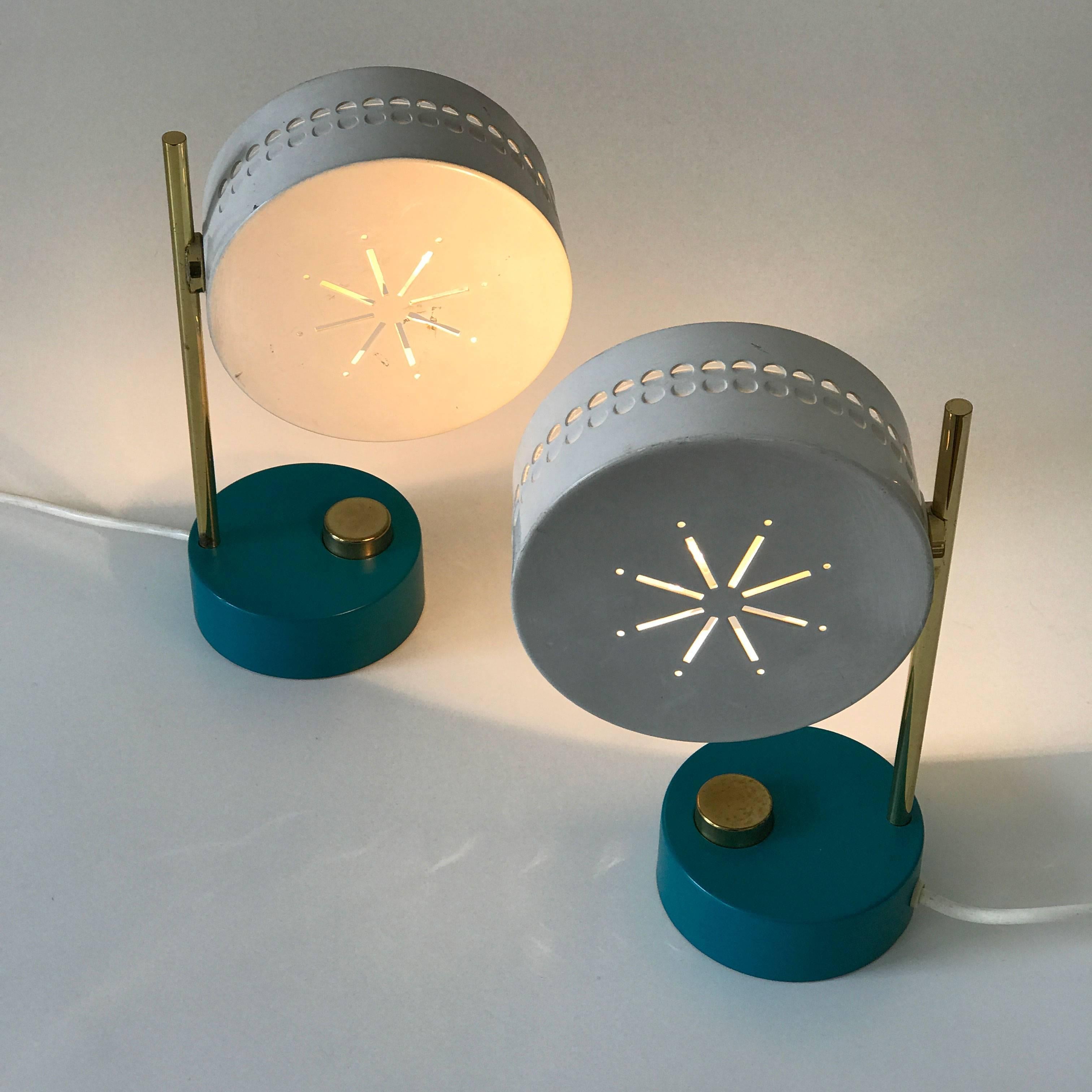 Two bedside table lamps. Designed by Mathieu Matégot attributed. Manufactured in 1950s. Each lamp needs one E14 screw fit bulb. Delivery without bulb. With rotating lamp shades and oversized brass switches on the base.